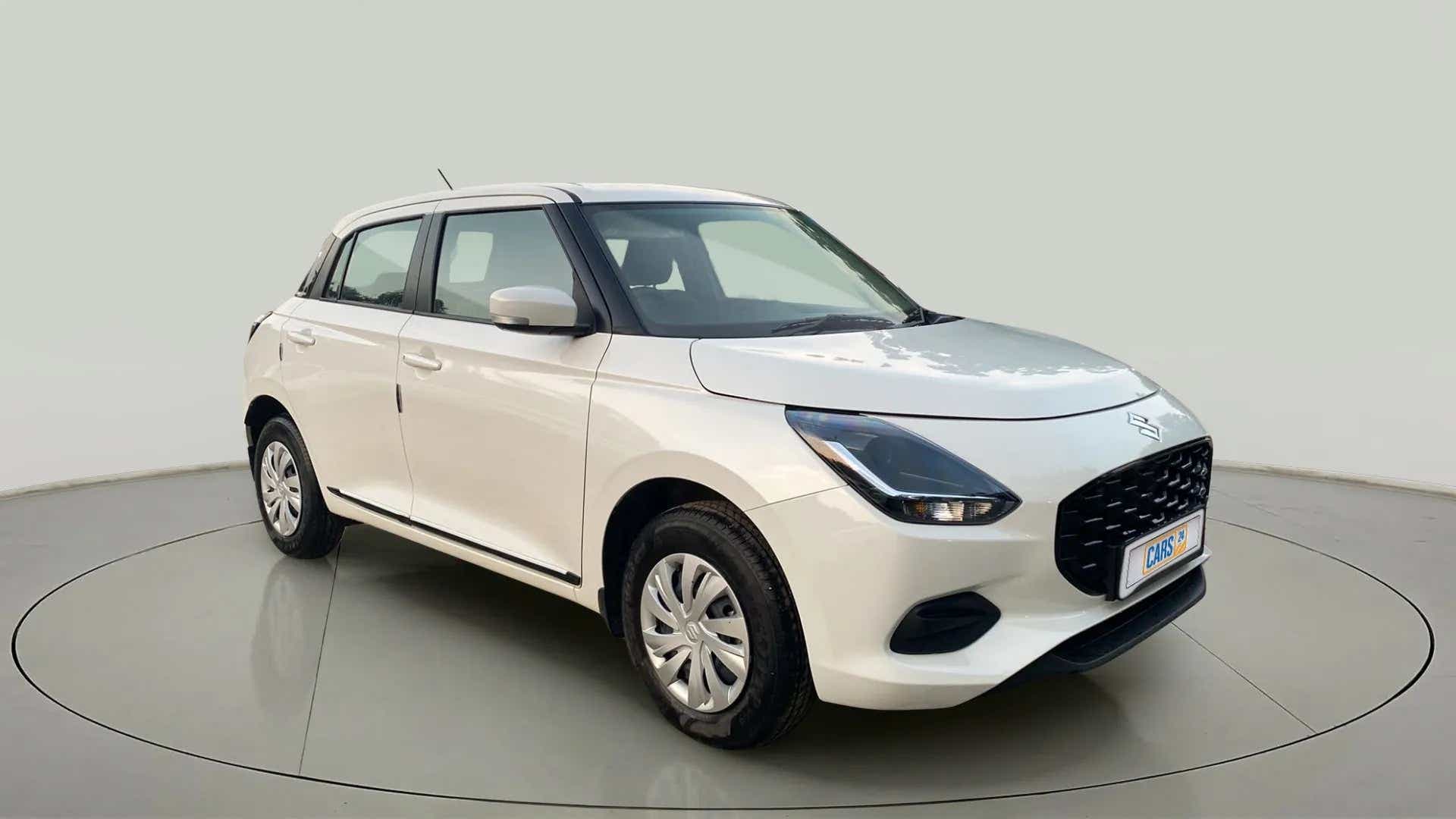 Front three quarter of a Pearl Arctic White with Pearl Midnight Black Maruti Suzuki Swift