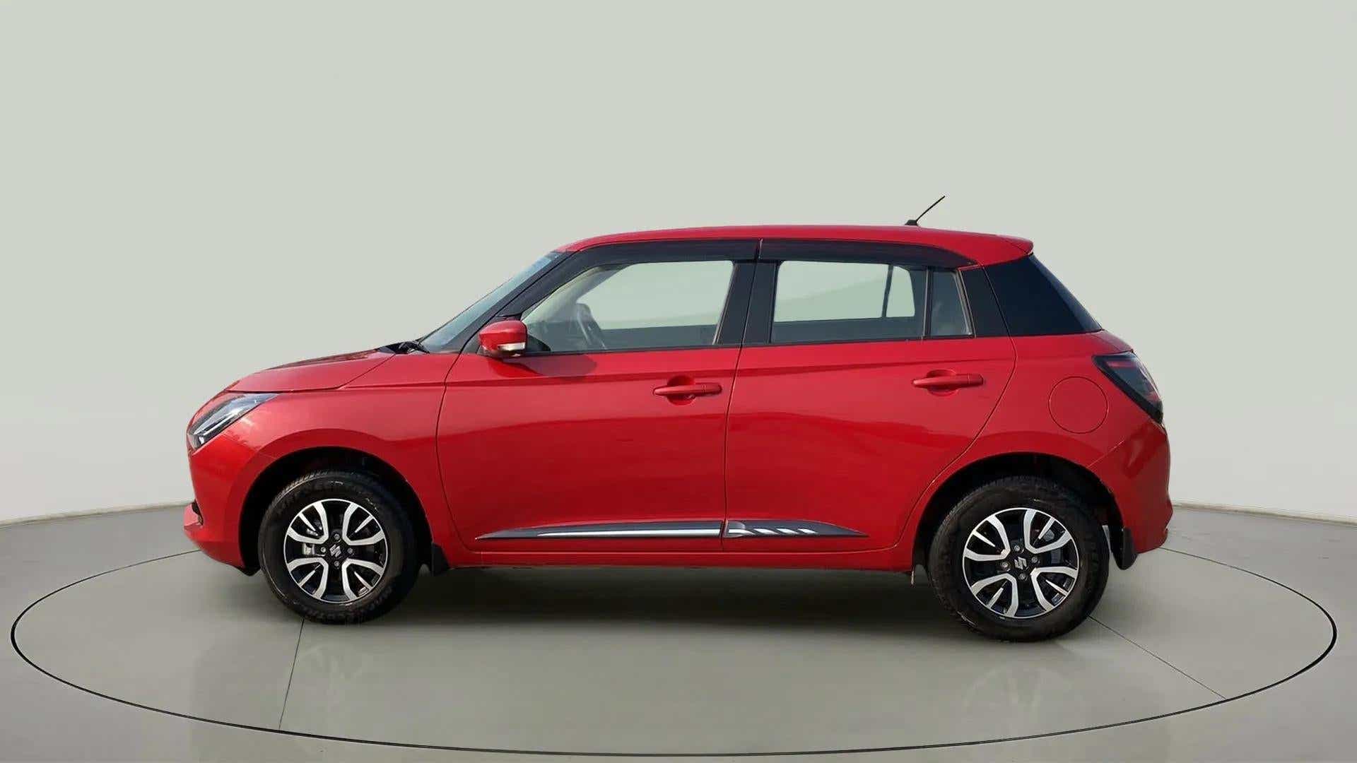 Side view of a Sizzling Red with Midnight Black Maruti Suzuki Swift