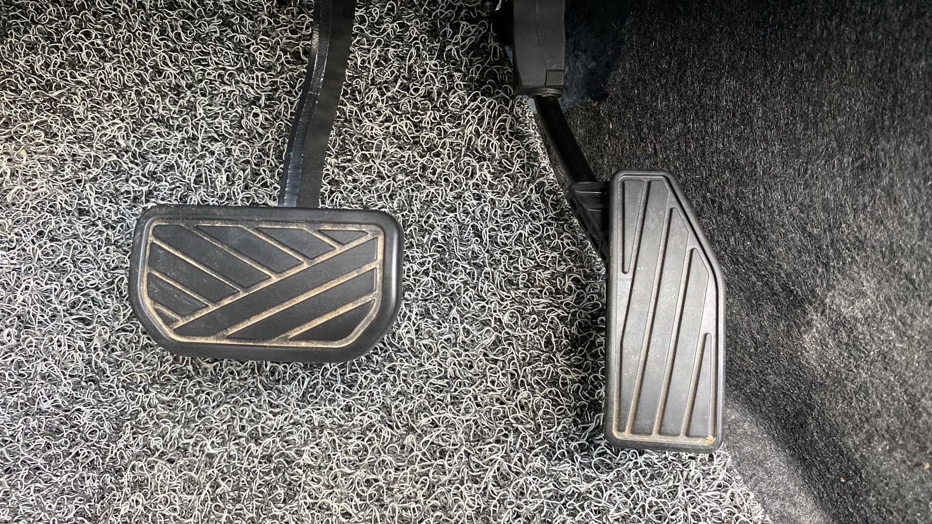 Close-up view of the foot pedals of a Maruti Suzuki Swift 2021 - 2023