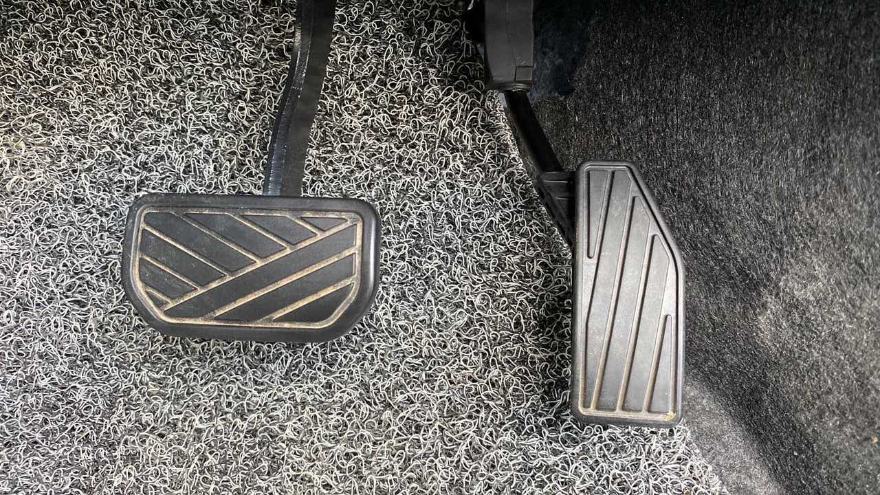 Close-up view of the foot pedals of a Maruti Suzuki Swift 2021 - 2023
