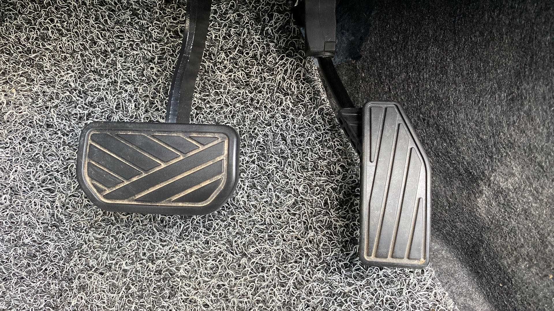 Close-up view of the foot pedals of a Maruti Suzuki Swift 2021 - 2023