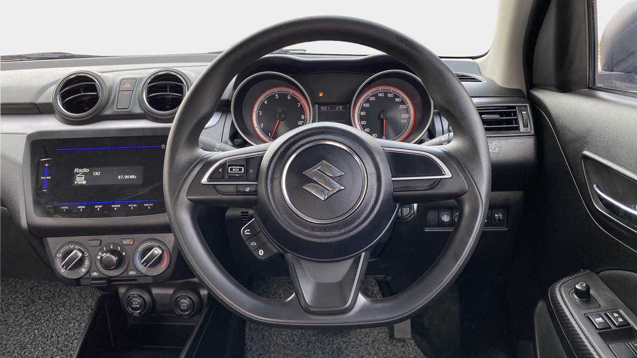 Dashboard and steering wheel view of a Maruti Suzuki Swift 2021 - 2023