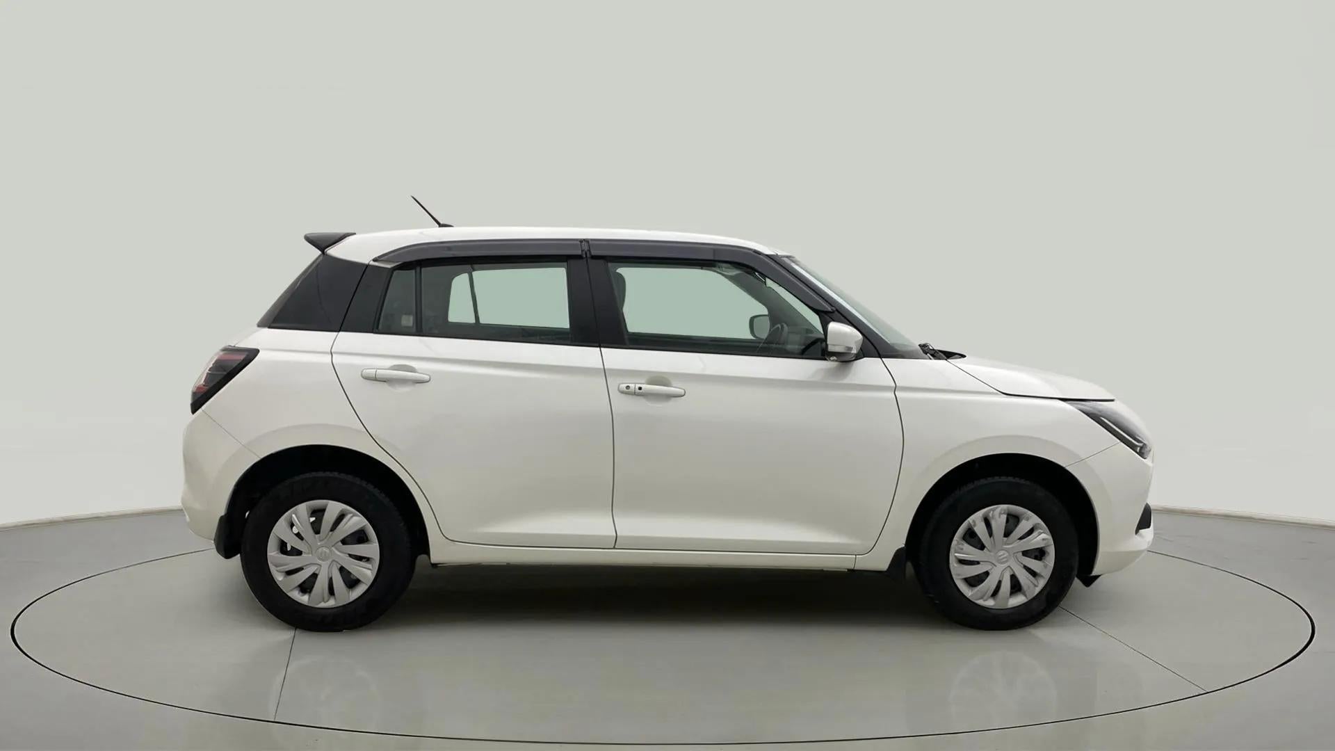Side view of a Pearl Arctic White with Pearl Midnight Black Maruti Suzuki Swift