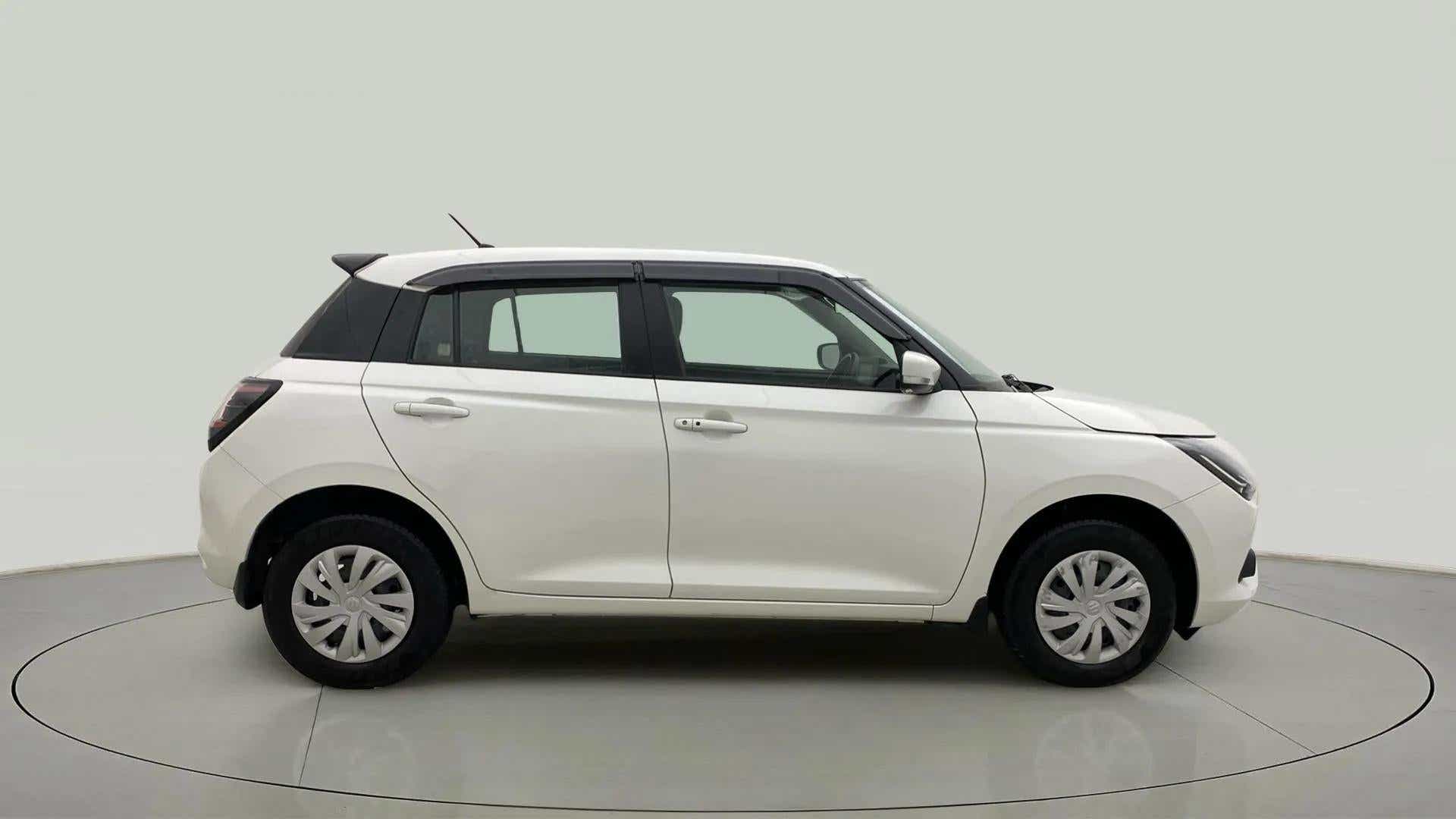Side view of a Pearl Arctic White with Pearl Midnight Black Maruti Suzuki Swift