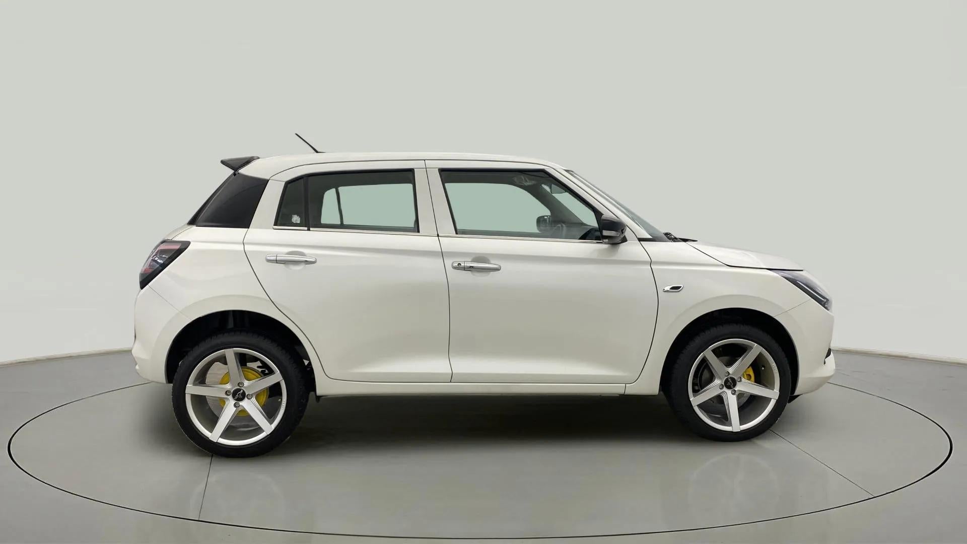 Side view of a Pearl Arctic White with Pearl Midnight Black Maruti Suzuki Swift