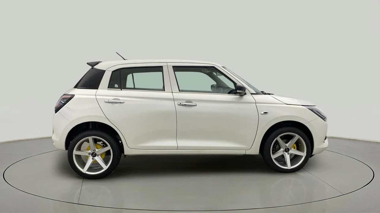 Side view of a Pearl Arctic White with Pearl Midnight Black Maruti Suzuki Swift