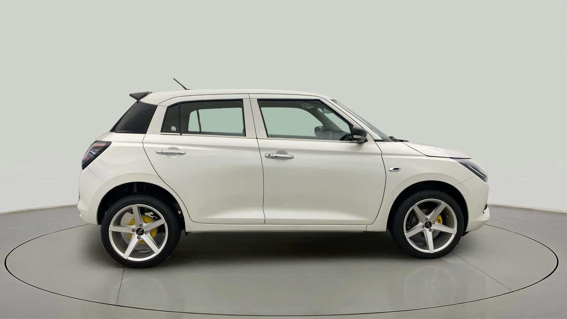 Side view of a Pearl Arctic White with Pearl Midnight Black Maruti Suzuki Swift