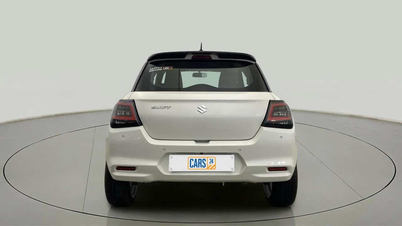 Rear view of a Pearl Arctic White with Pearl Midnight Black Maruti Suzuki Swift