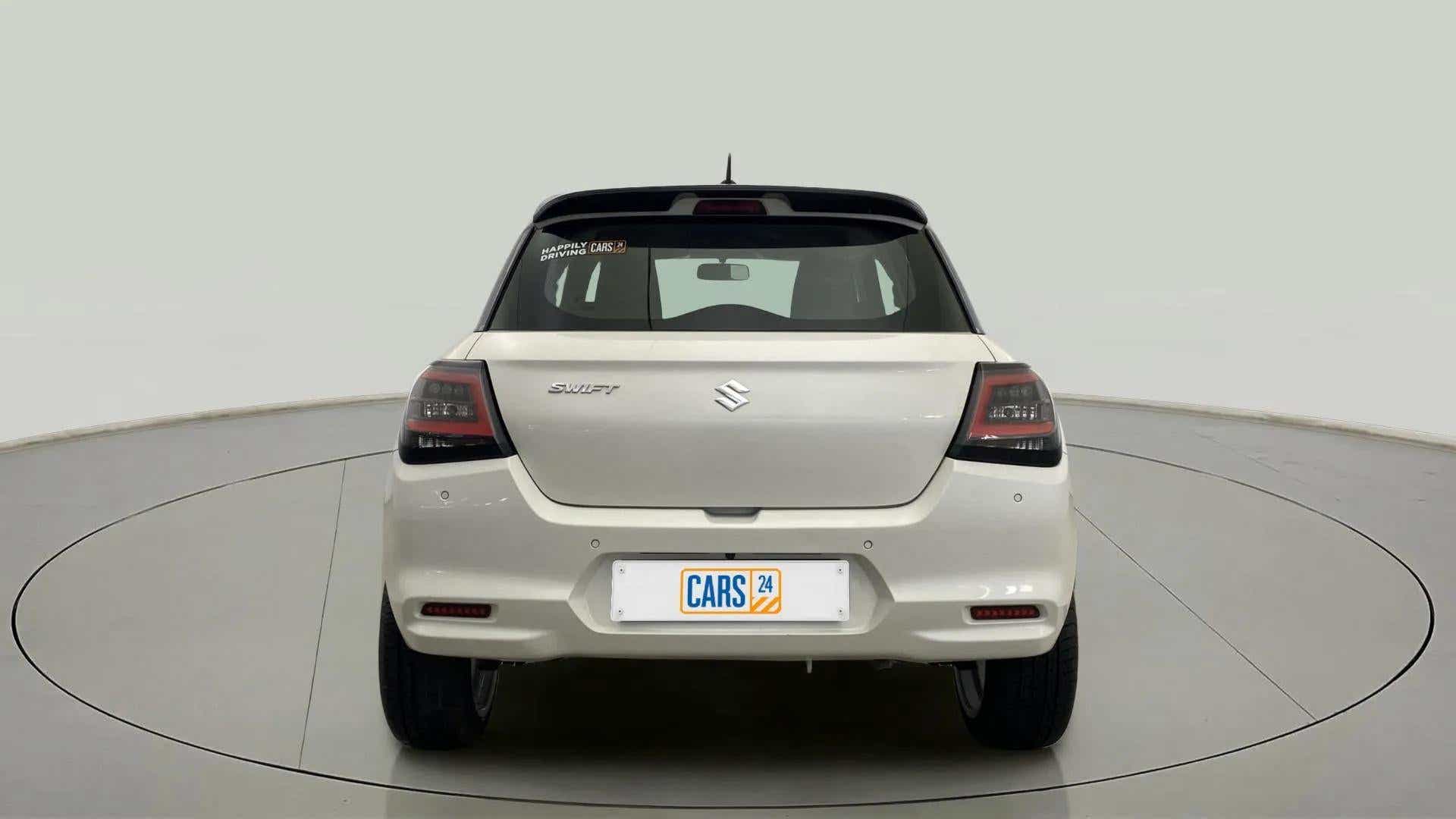 Rear view of a Pearl Arctic White with Pearl Midnight Black Maruti Suzuki Swift
