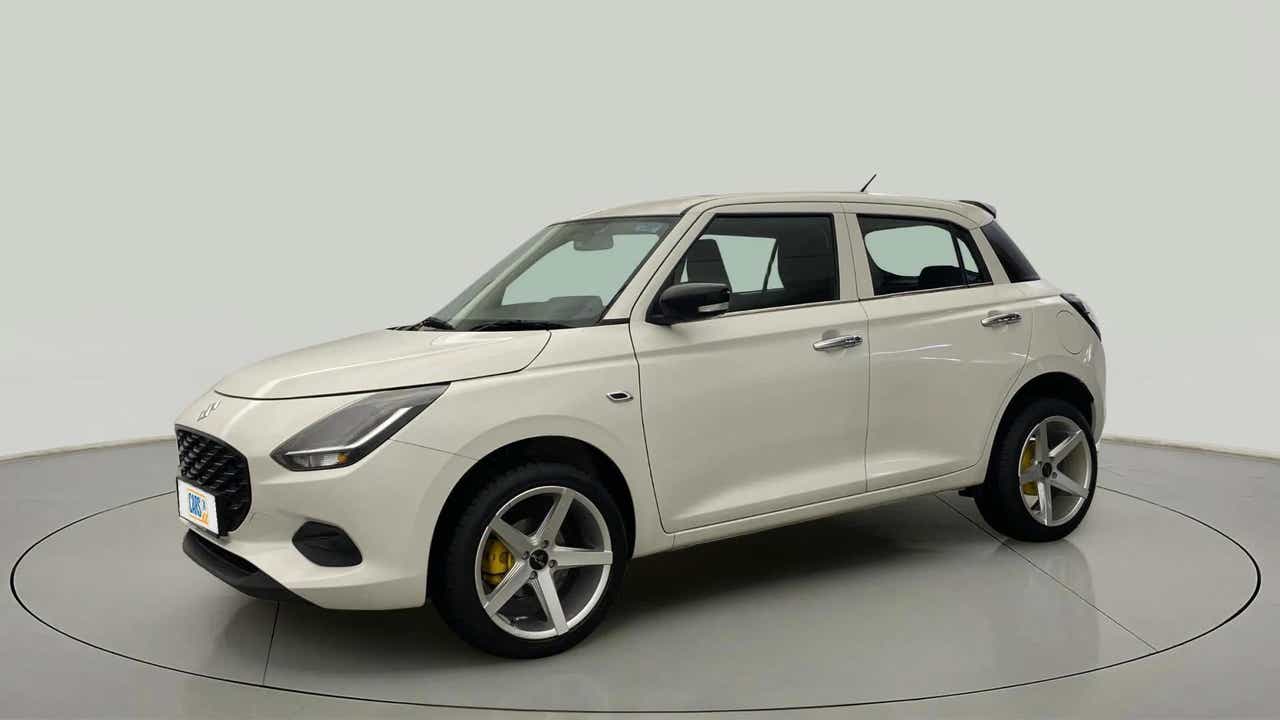 Front three-quarter view of a Pearl Arctic White with Pearl Midnight Black Maruti Suzuki Swift