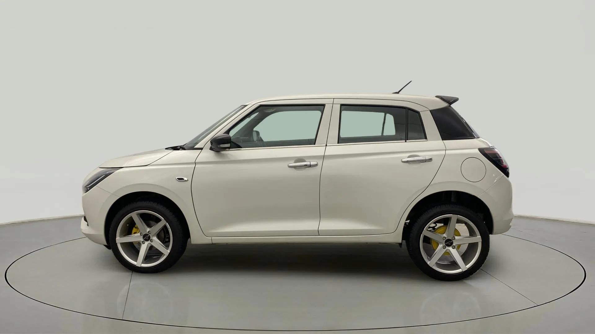 Side view of a Pearl Arctic White with Pearl Midnight Black Maruti Suzuki Swift