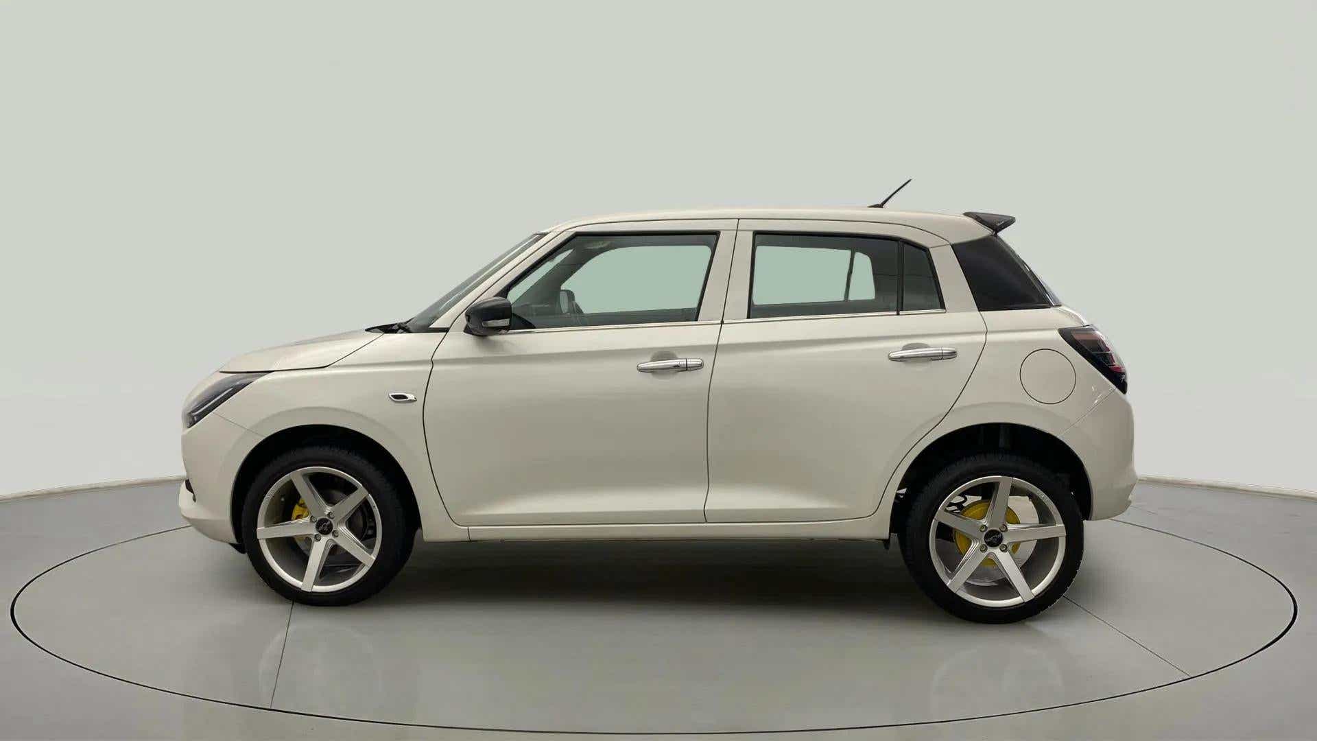 Side view of a Pearl Arctic White with Pearl Midnight Black Maruti Suzuki Swift