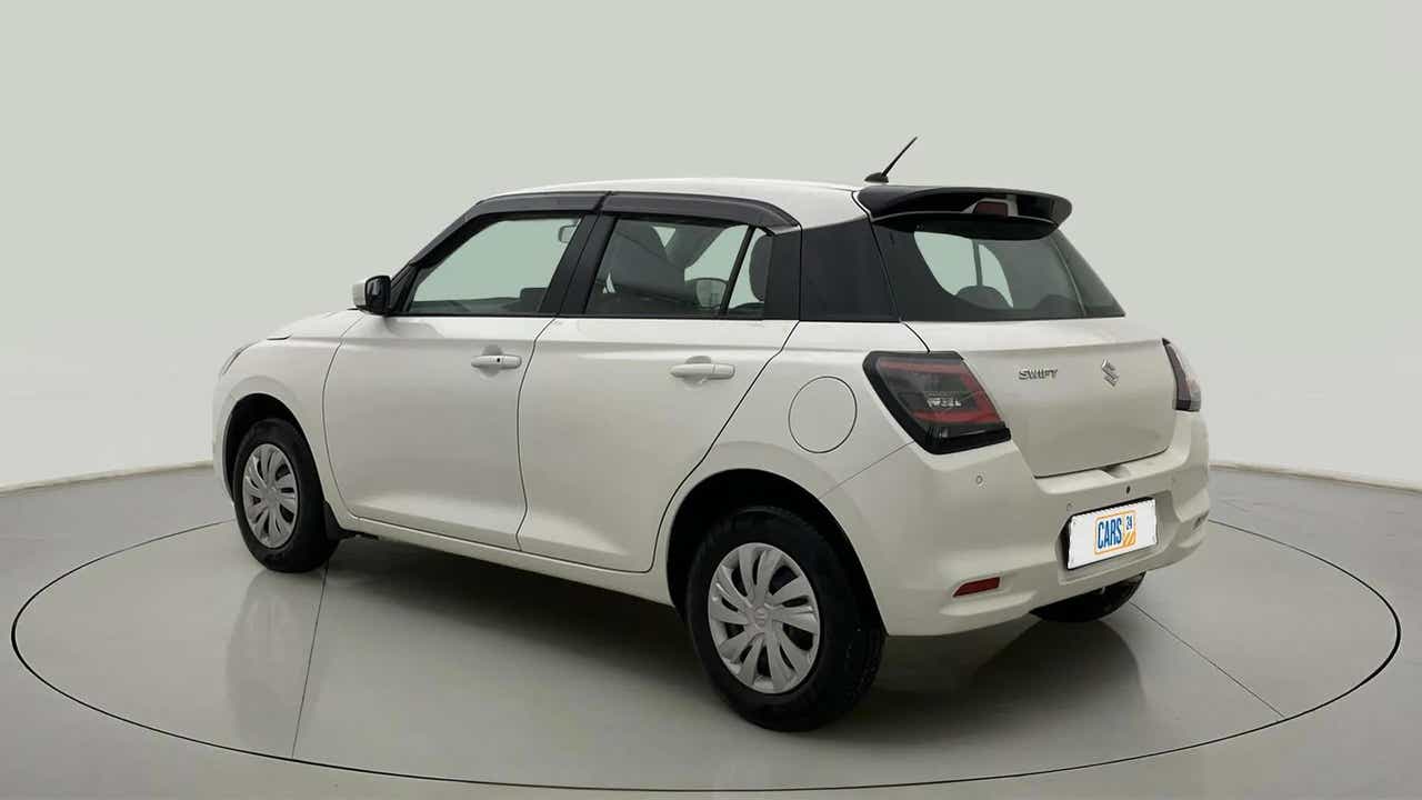Rear three-quarter of a Pearl Arctic White with Pearl Midnight Black Maruti Suzuki Swift