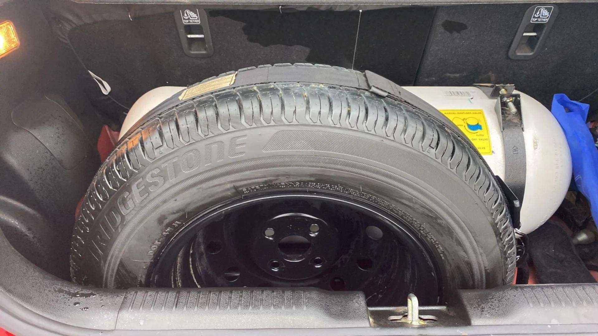Boot space with spare tyre and cng tank of a maruti suzuki swift 2021 - 2023