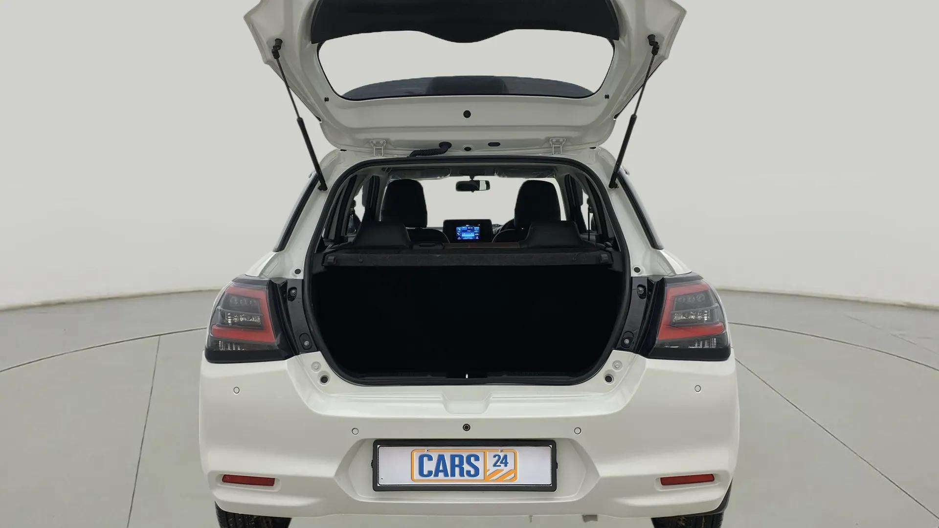 Rear view of a Pearl Arctic White with Pearl Midnight Black Maruti Suzuki Swift with the boot open