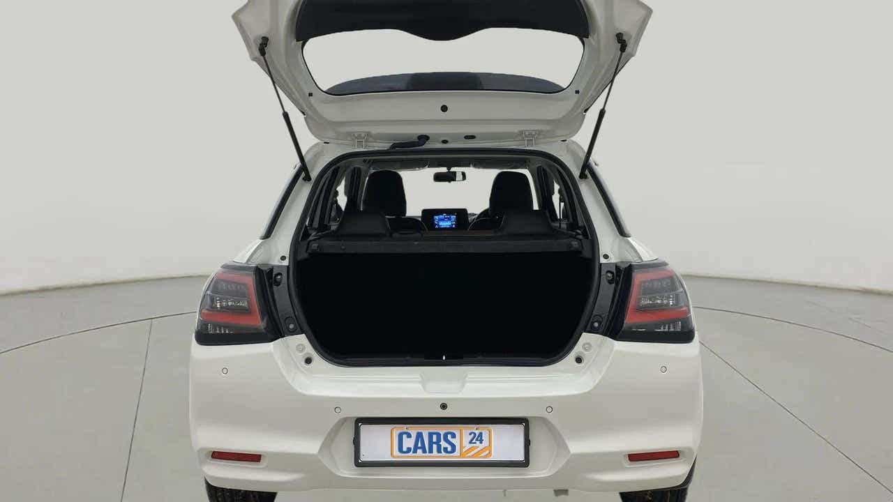 Rear view of a Pearl Arctic White with Pearl Midnight Black Maruti Suzuki Swift with the boot open