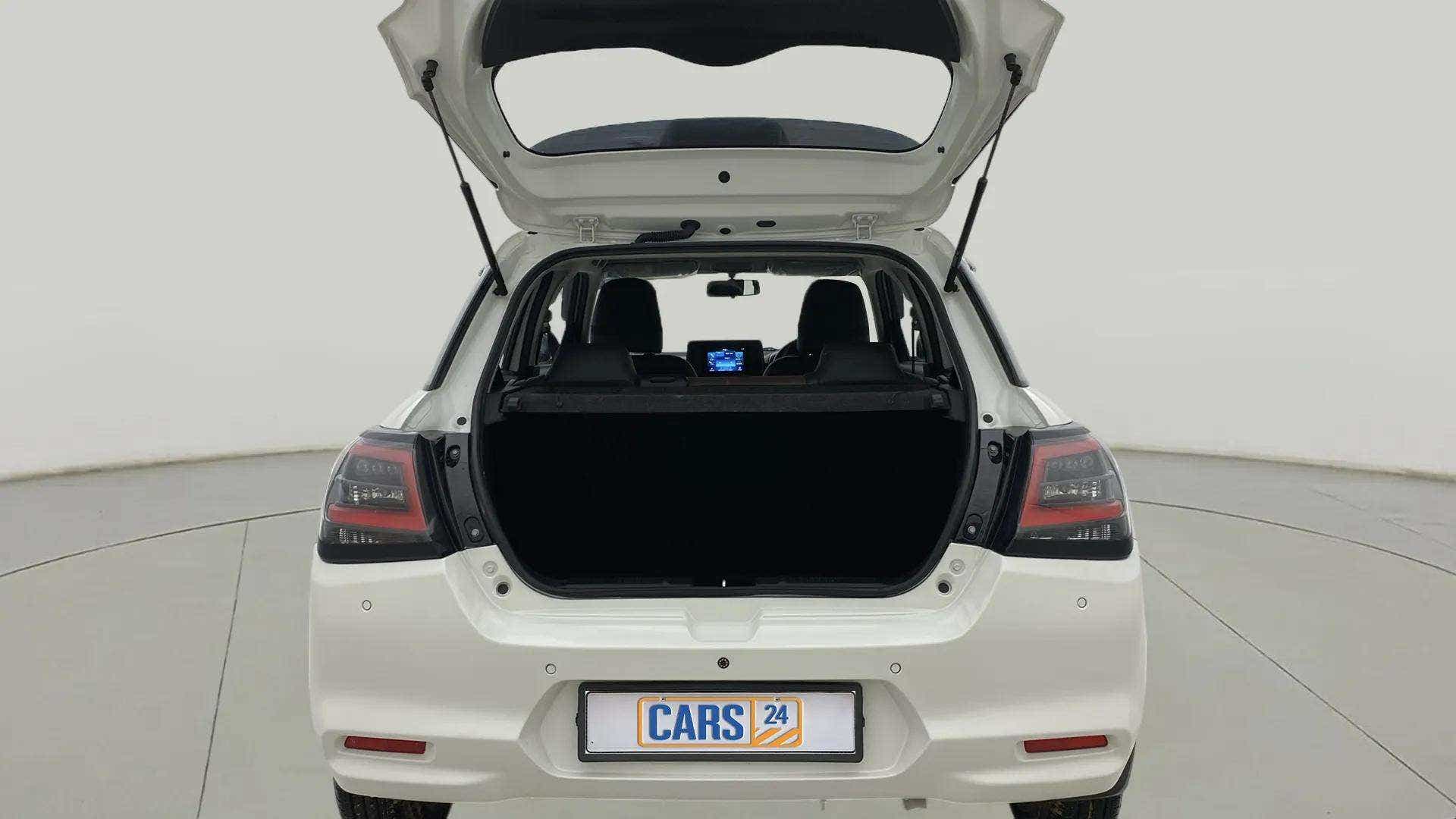 Rear view of a Pearl Arctic White with Pearl Midnight Black Maruti Suzuki Swift with the boot open