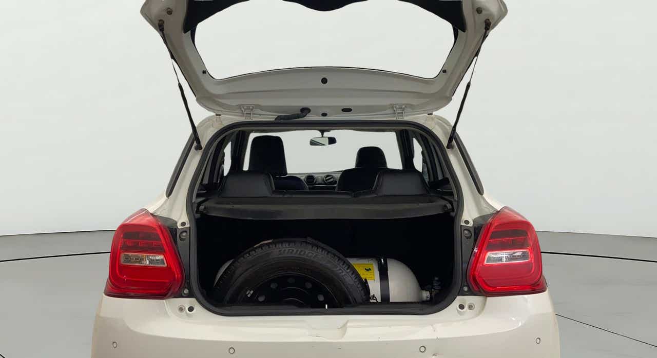 Open boot view of a pearl arctic white Maruti Suzuki Swift