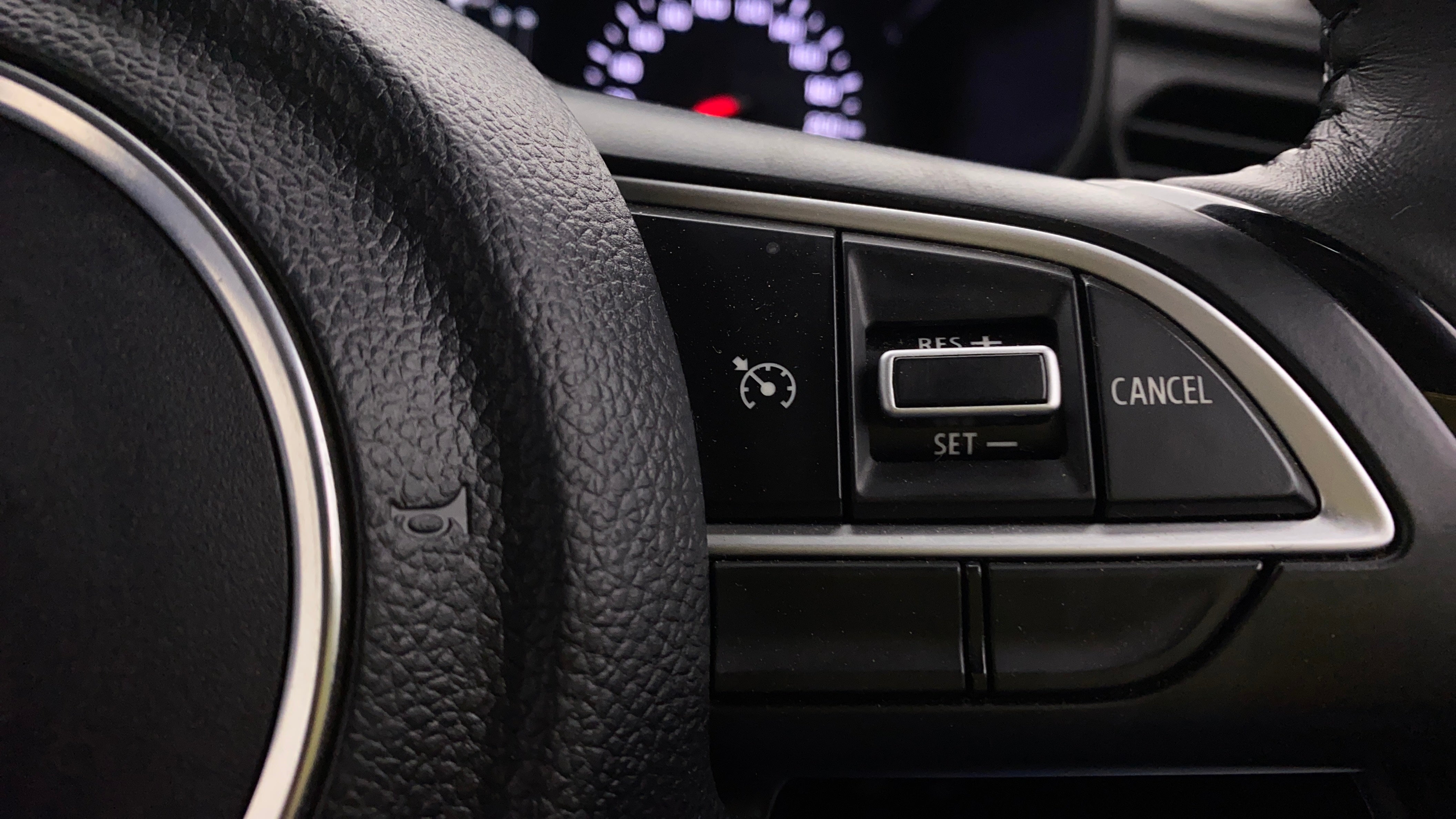 Steering wheel cruise control buttons of a Maruti Suzuki Swift