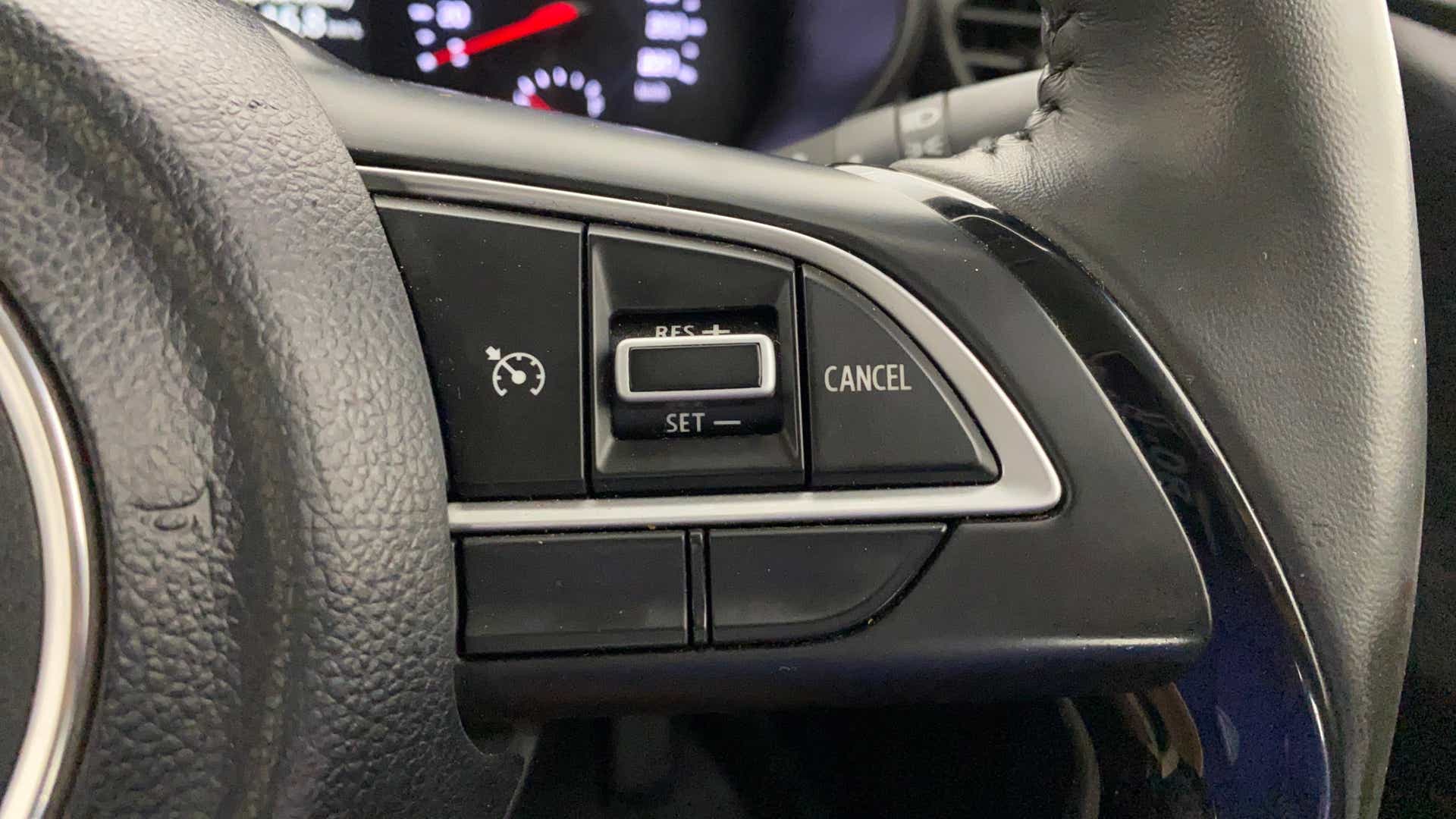 Steering wheel cruise control buttons of a Maruti Suzuki Swift