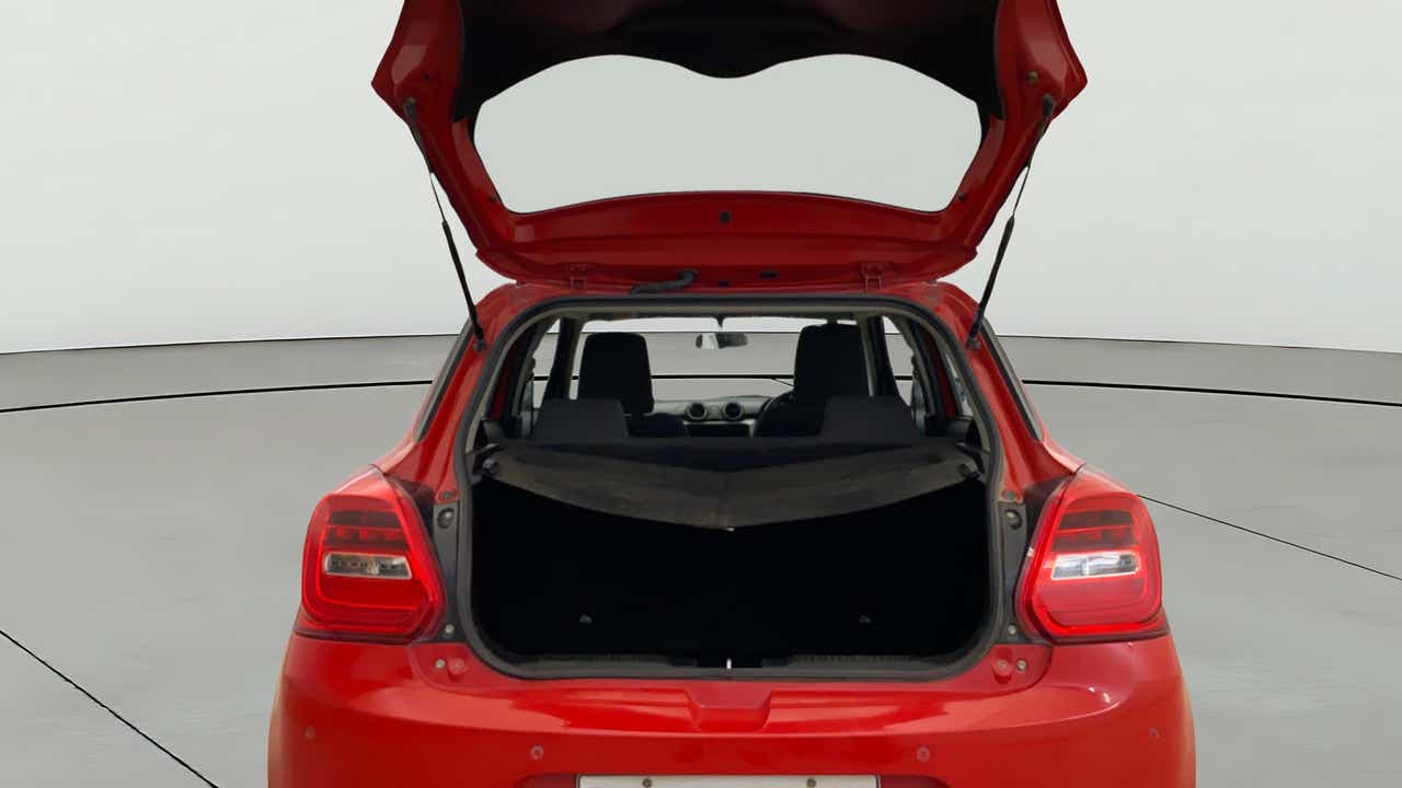 Open boot view of a solid fire red with pearl midnight black roof Maruti Suzuki Swift 2021 - 2023