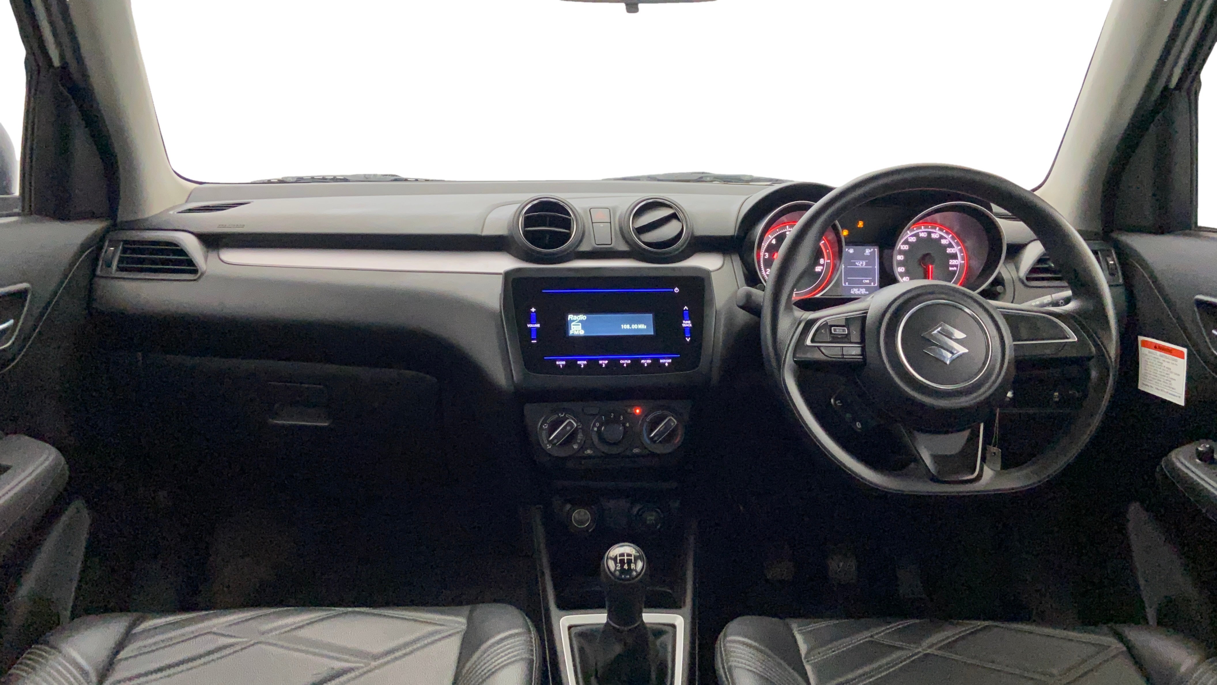 Interior dashboard view of a Maruti Suzuki Swift