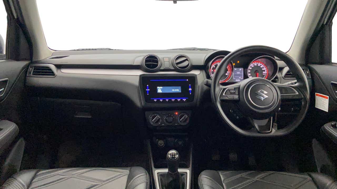 Interior dashboard view of a Maruti Suzuki Swift