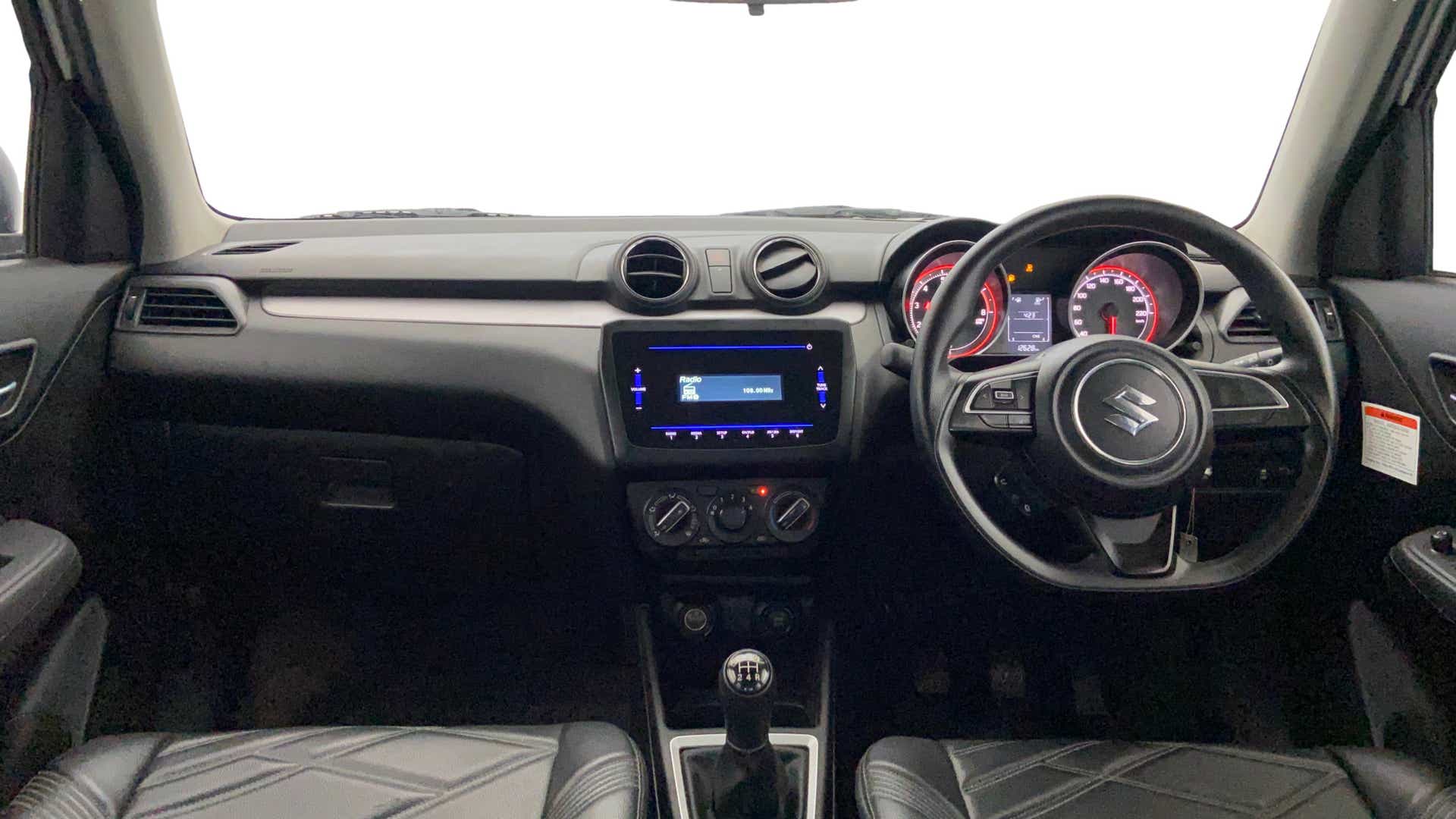 Interior dashboard view of a Maruti Suzuki Swift