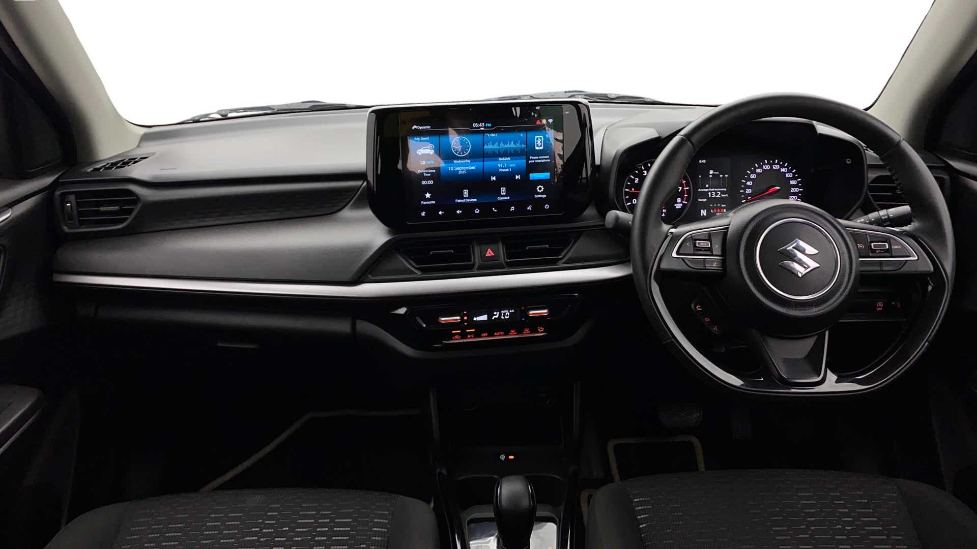 Dashboard and steering wheel of a Maruti Suzuki Swift