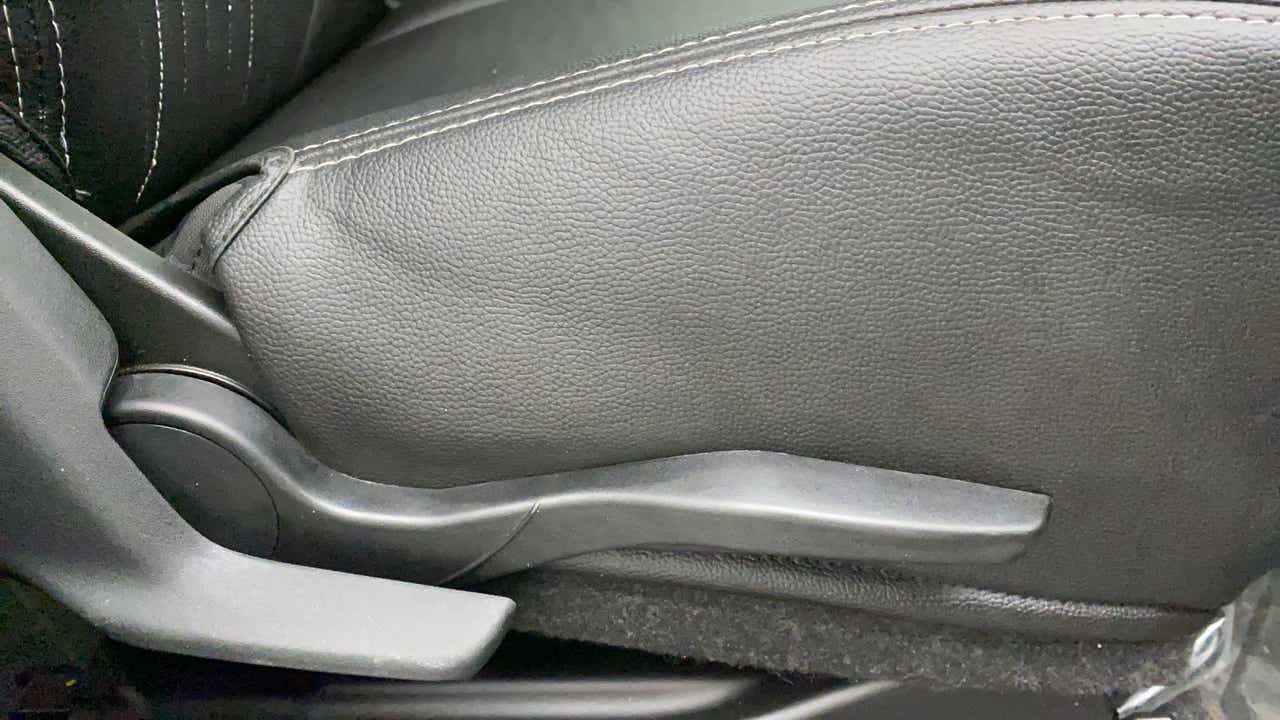 Close-up view of a Maruti Suzuki Swift 2021 - 2023 car seat adjustment lever