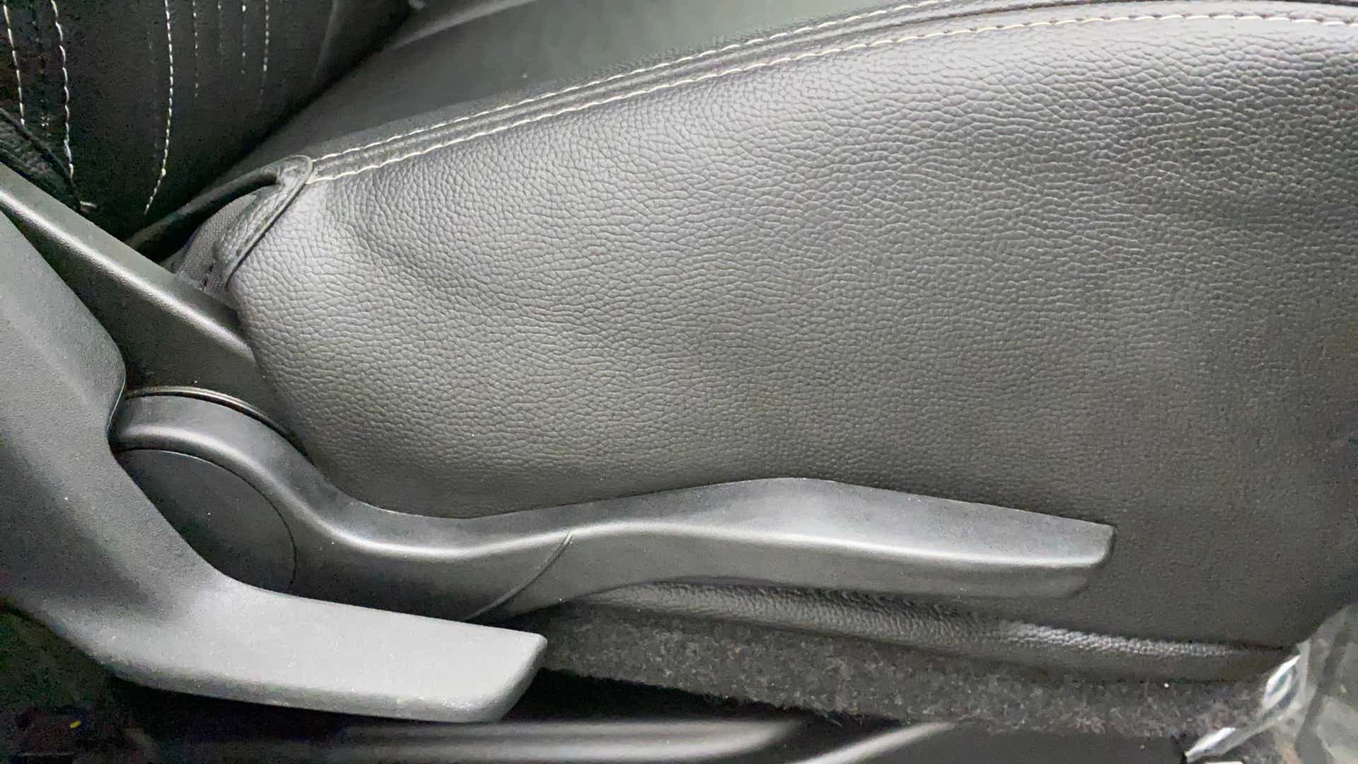 Close-up view of a Maruti Suzuki Swift 2021 - 2023 car seat adjustment lever