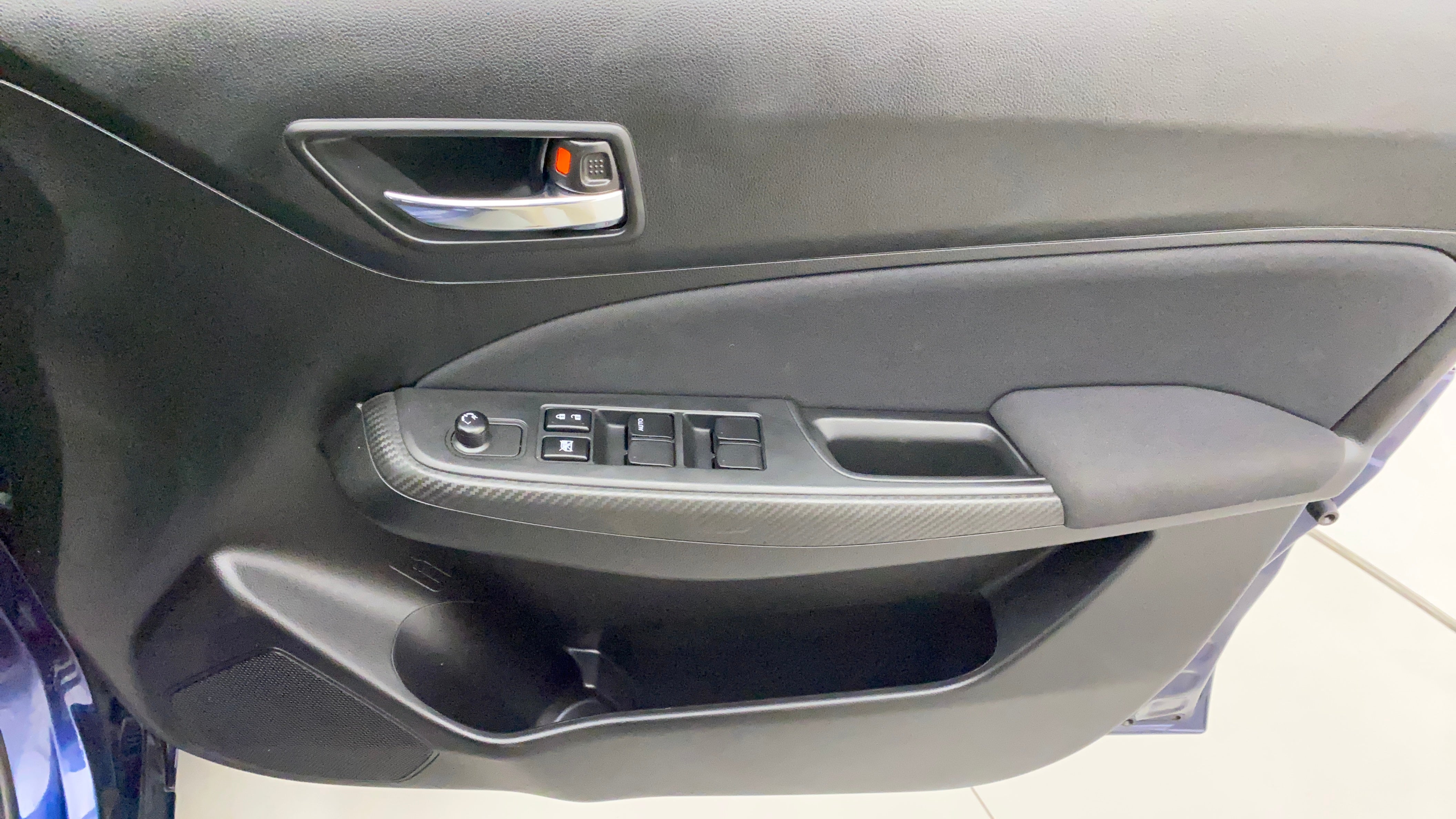 Interior driver side door panel of a Maruti Suzuki Swift 2021 - 2023