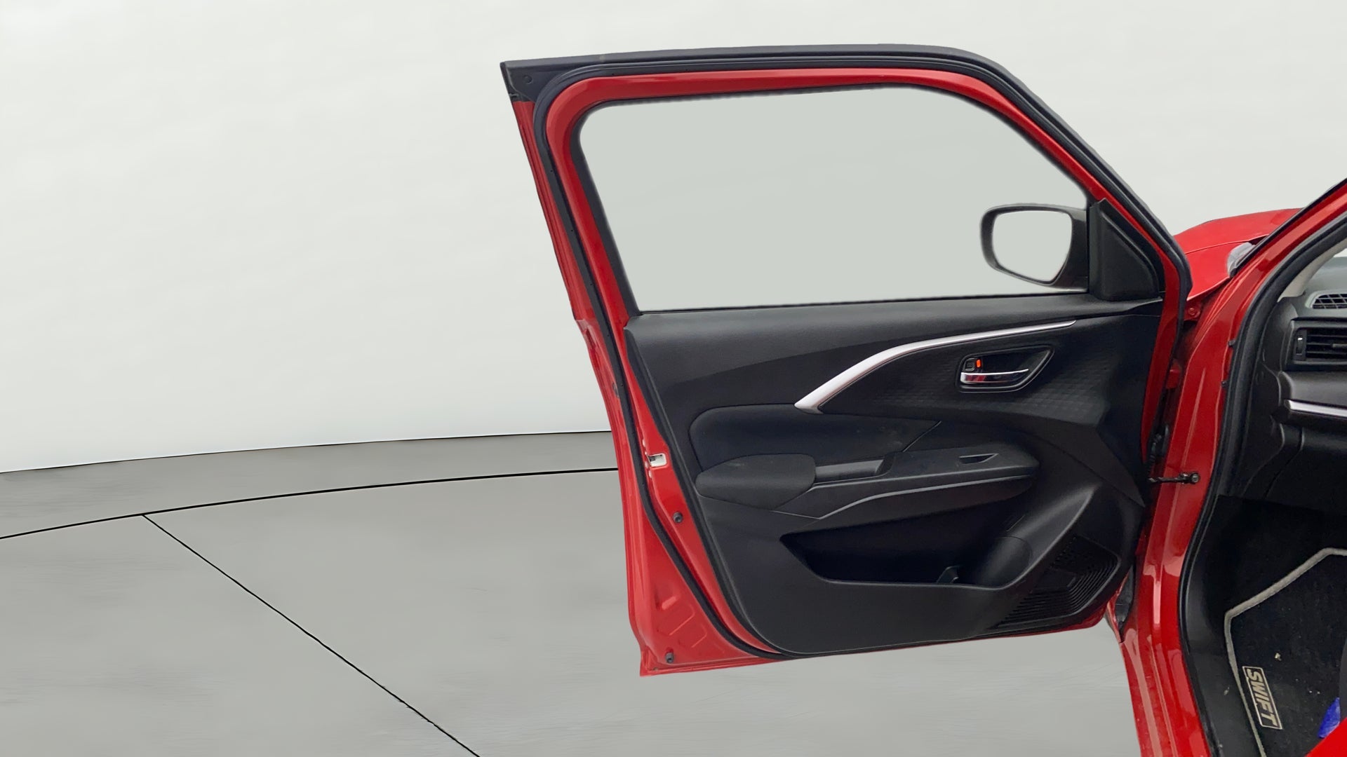 Front driver-side door interior of a Maruti Suzuki Swift