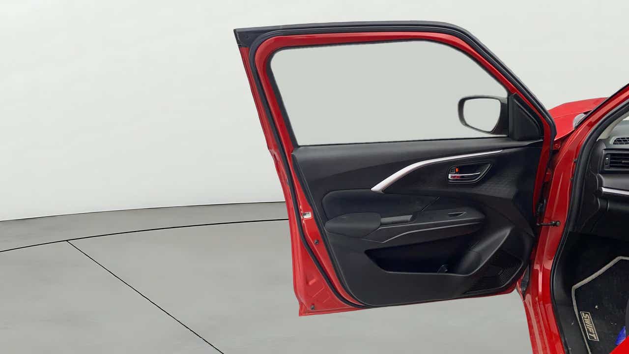 Front driver-side door interior of a Maruti Suzuki Swift