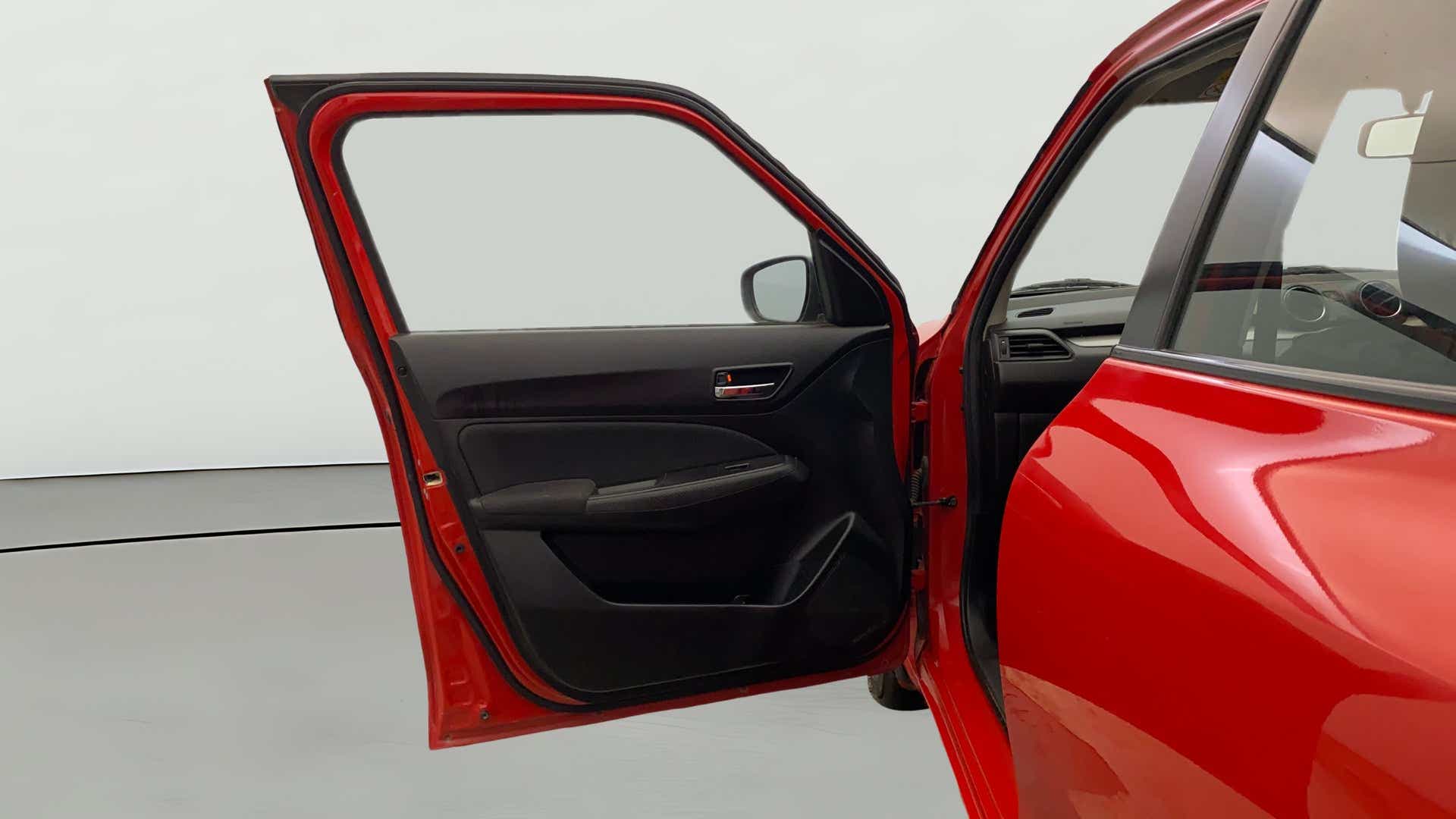 Front door and partial interior view of a Maruti Suzuki Swift 2021 - 2023