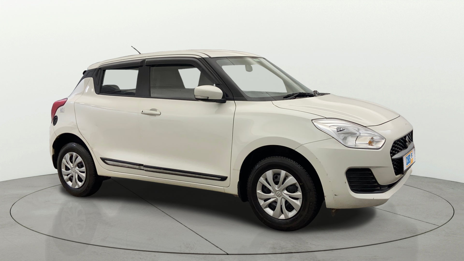 Side view of a Pearl Arctic White Maruti Suzuki Swift