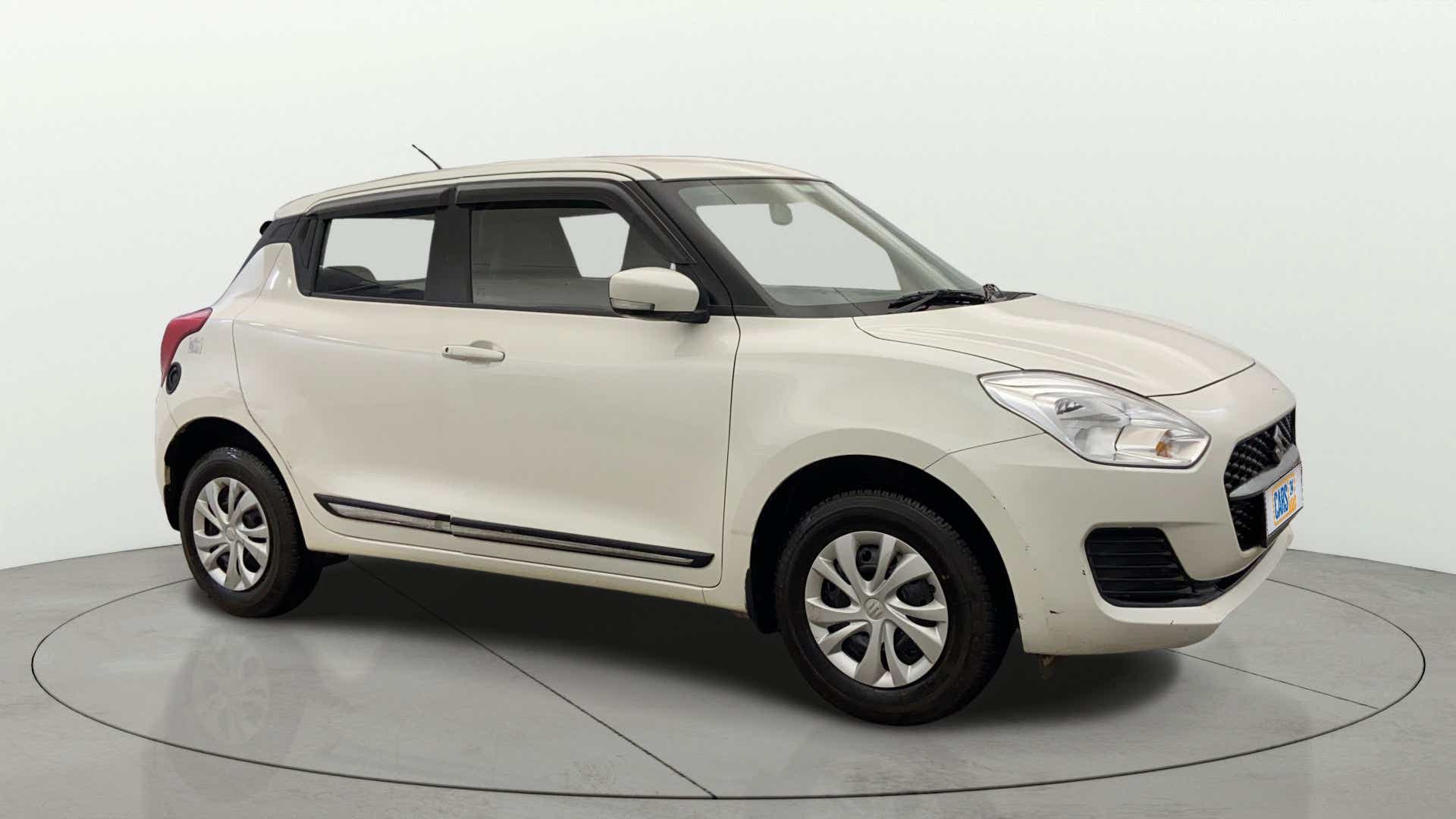 Side view of a Pearl Arctic White Maruti Suzuki Swift