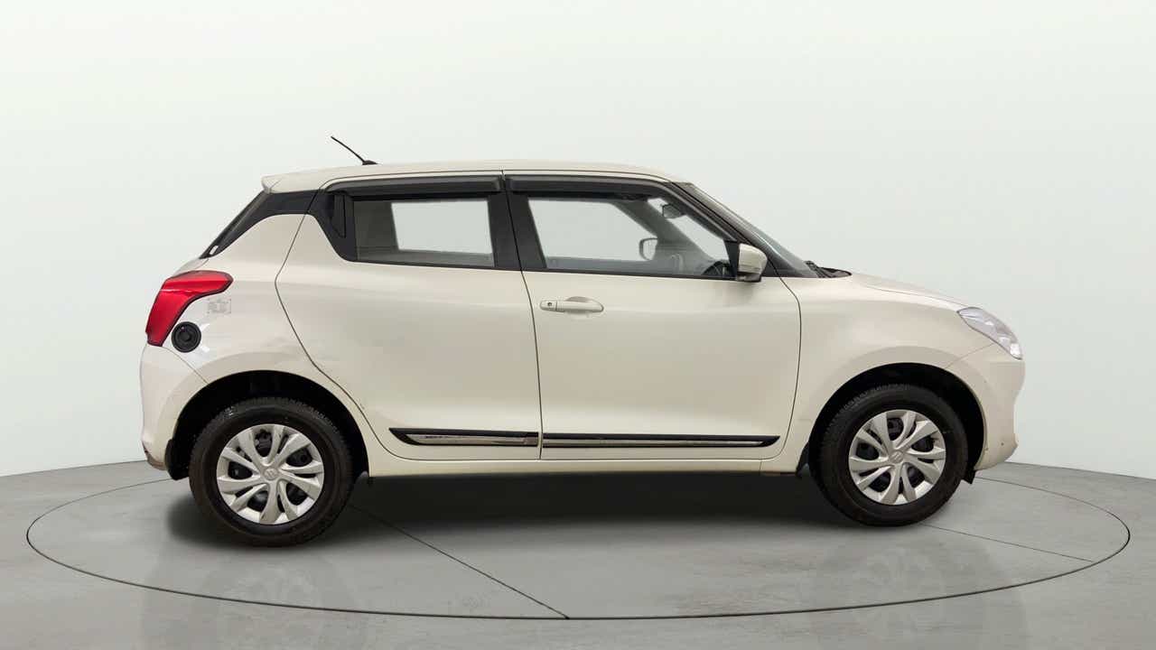 Side view of a Pearl Arctic White with Pearl Midnight Black Maruti Suzuki Swift