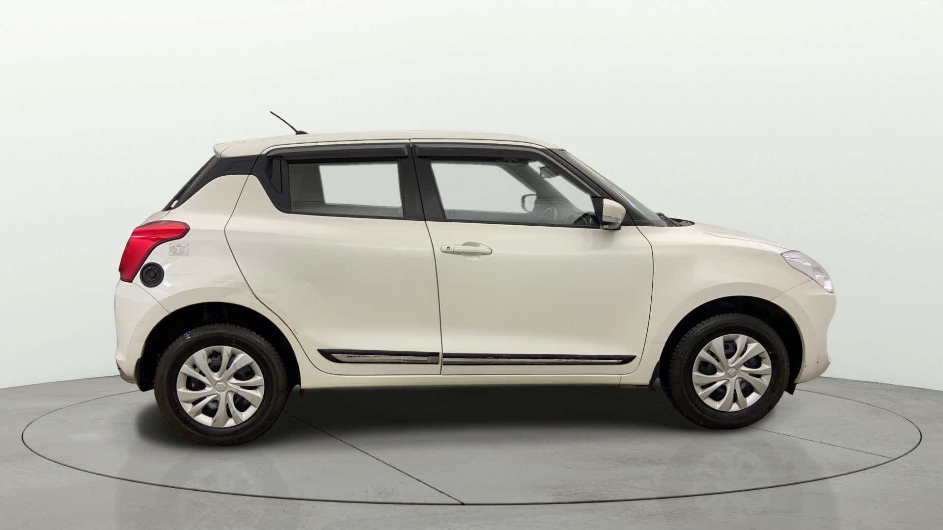 Side view of a Pearl Arctic White with Pearl Midnight Black Maruti Suzuki Swift