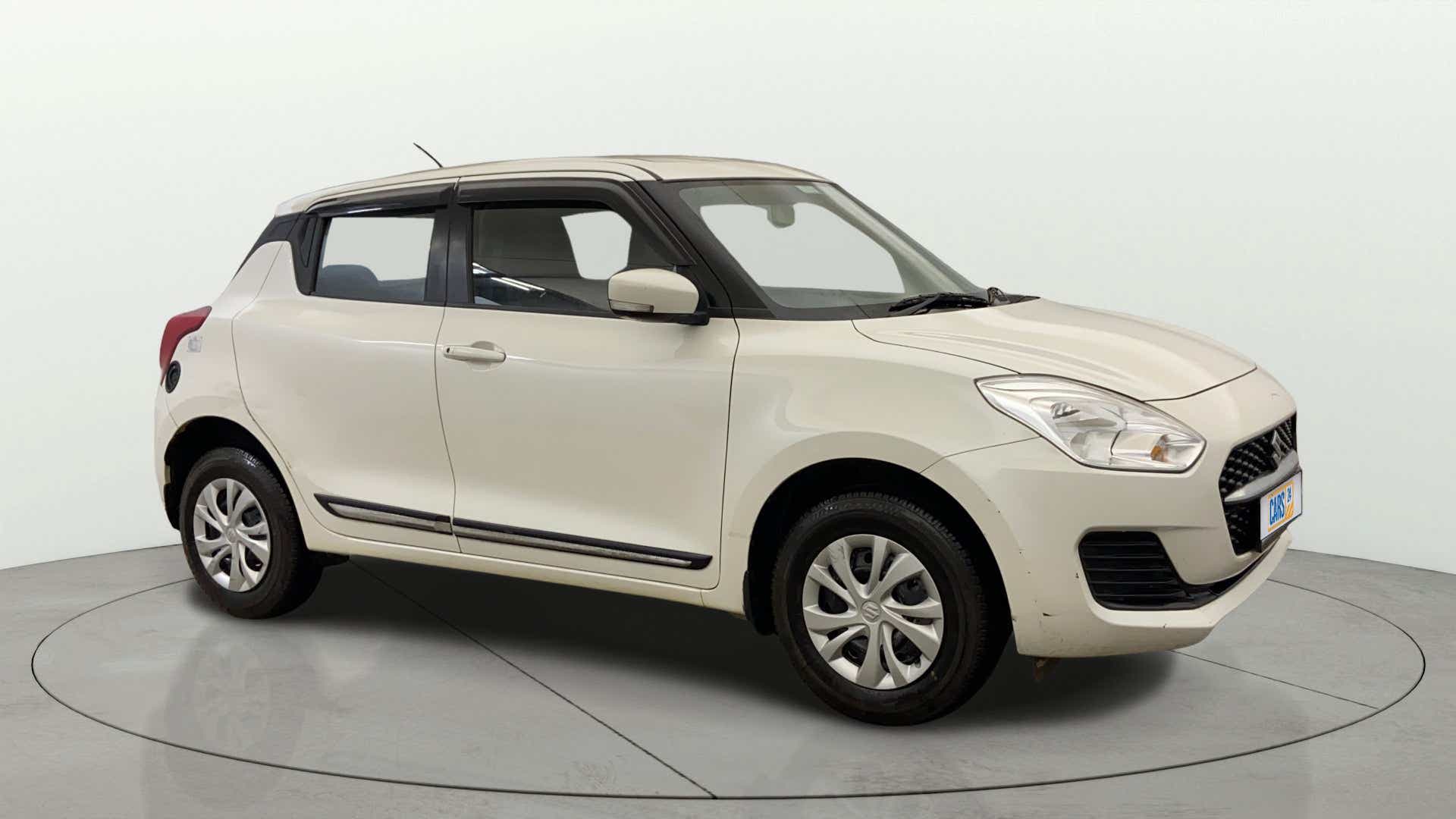 Front three-quarter view of a Pearl Arctic White with Pearl Midnight Black Maruti Suzuki Swift