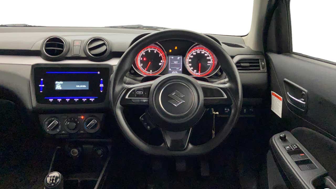 Dashboard and steering wheel view of a Maruti Suzuki Swift
