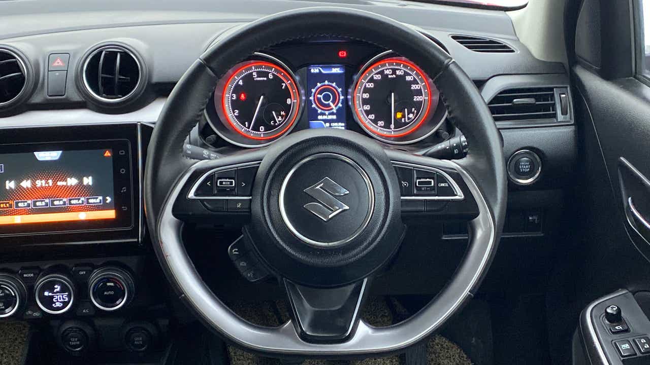 Dashboard and steering wheel view of a Maruti Suzuki Swift 2021 - 2023