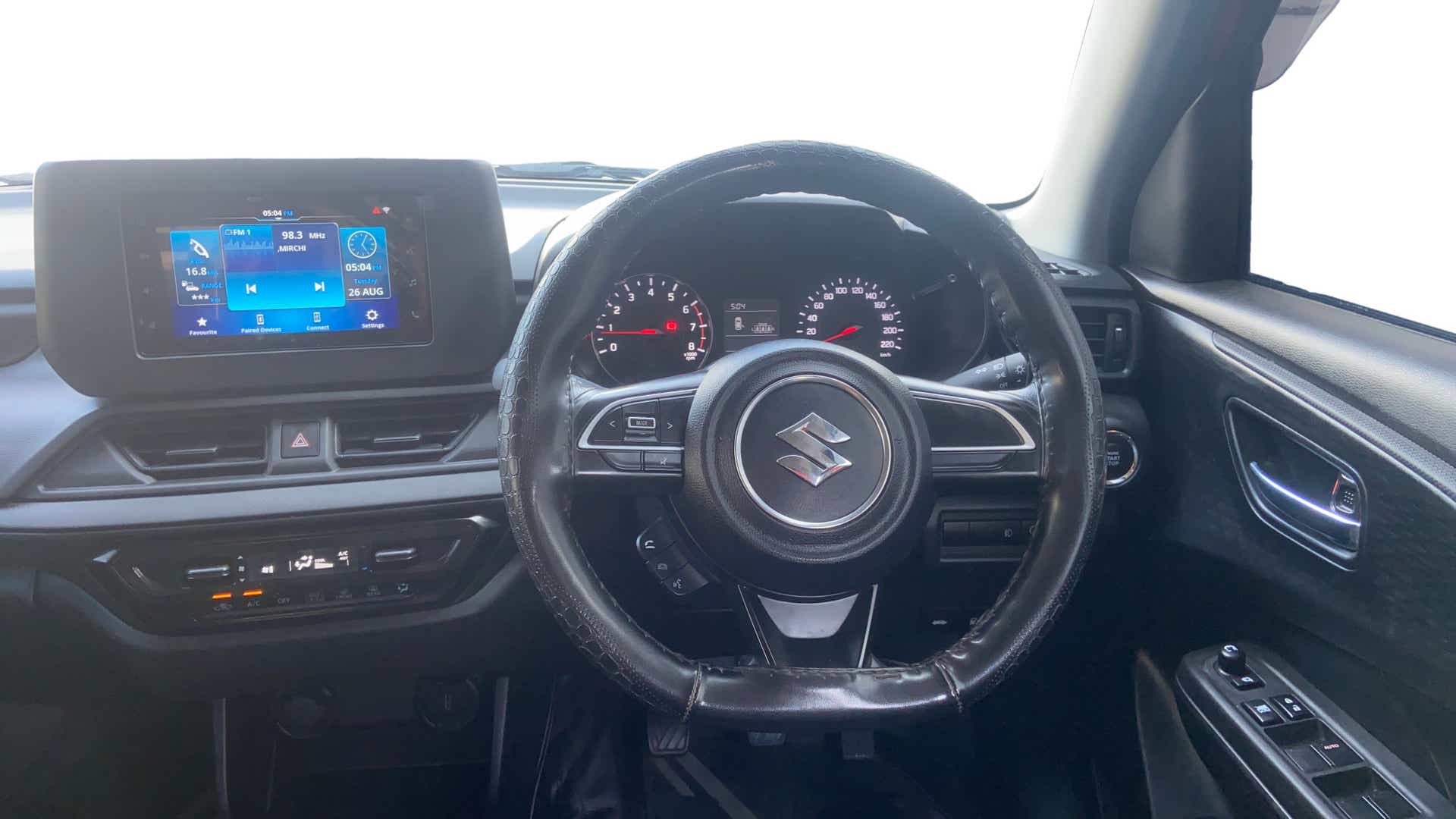 Dashboard and steering wheel view of a Maruti Suzuki Swift