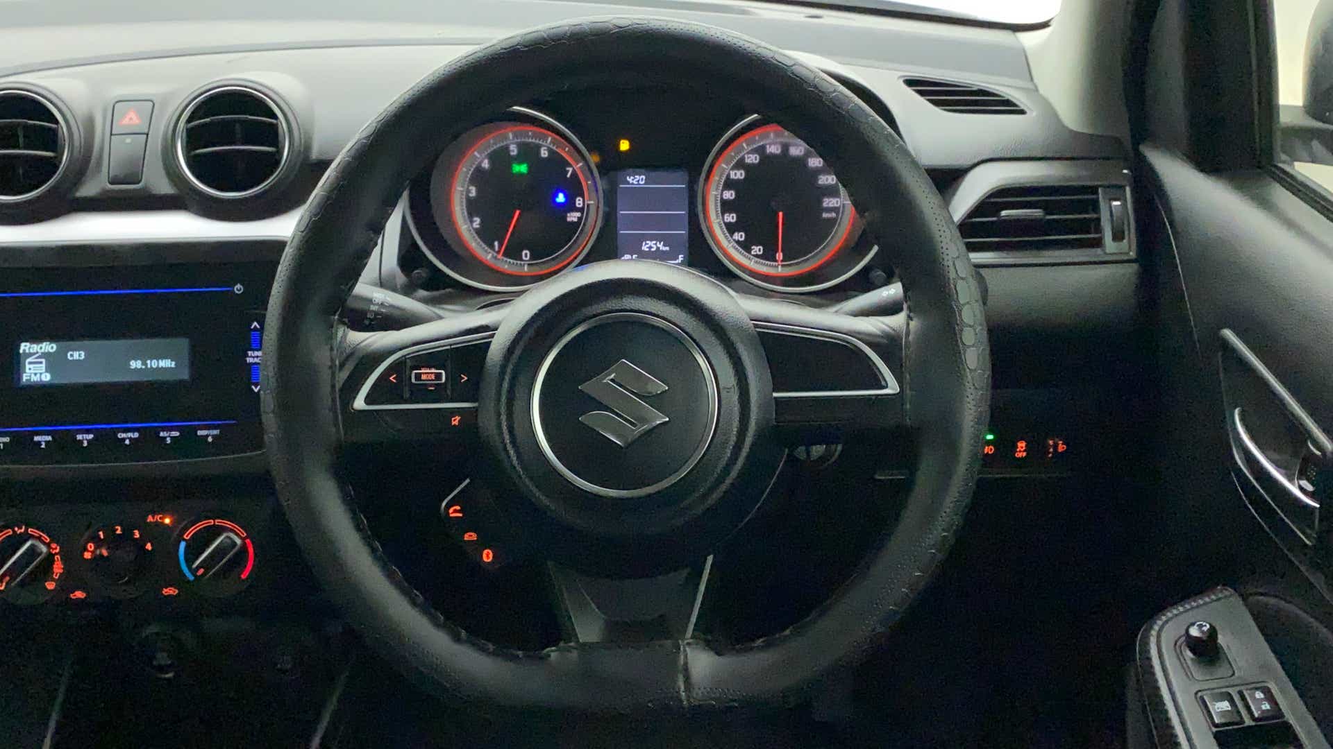 Steering wheel and dashboard of a Maruti Suzuki Swift 2021 - 2023