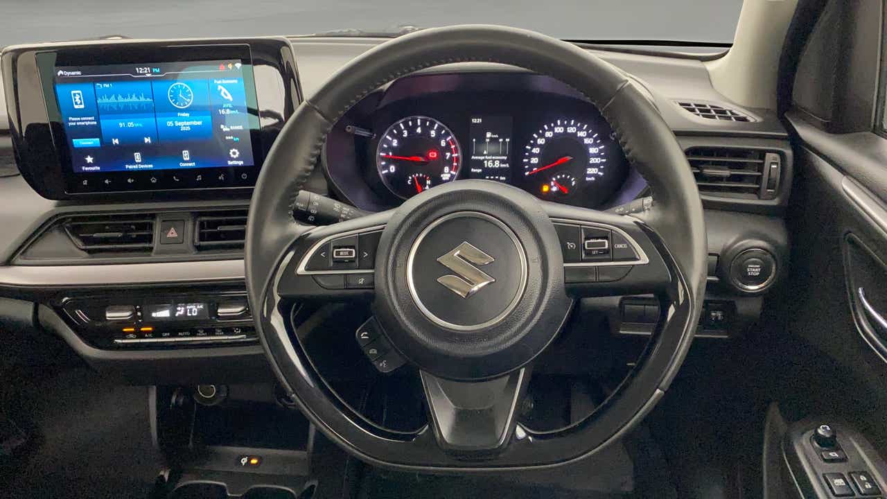 Dashboard and steering wheel of a Maruti Suzuki Swift