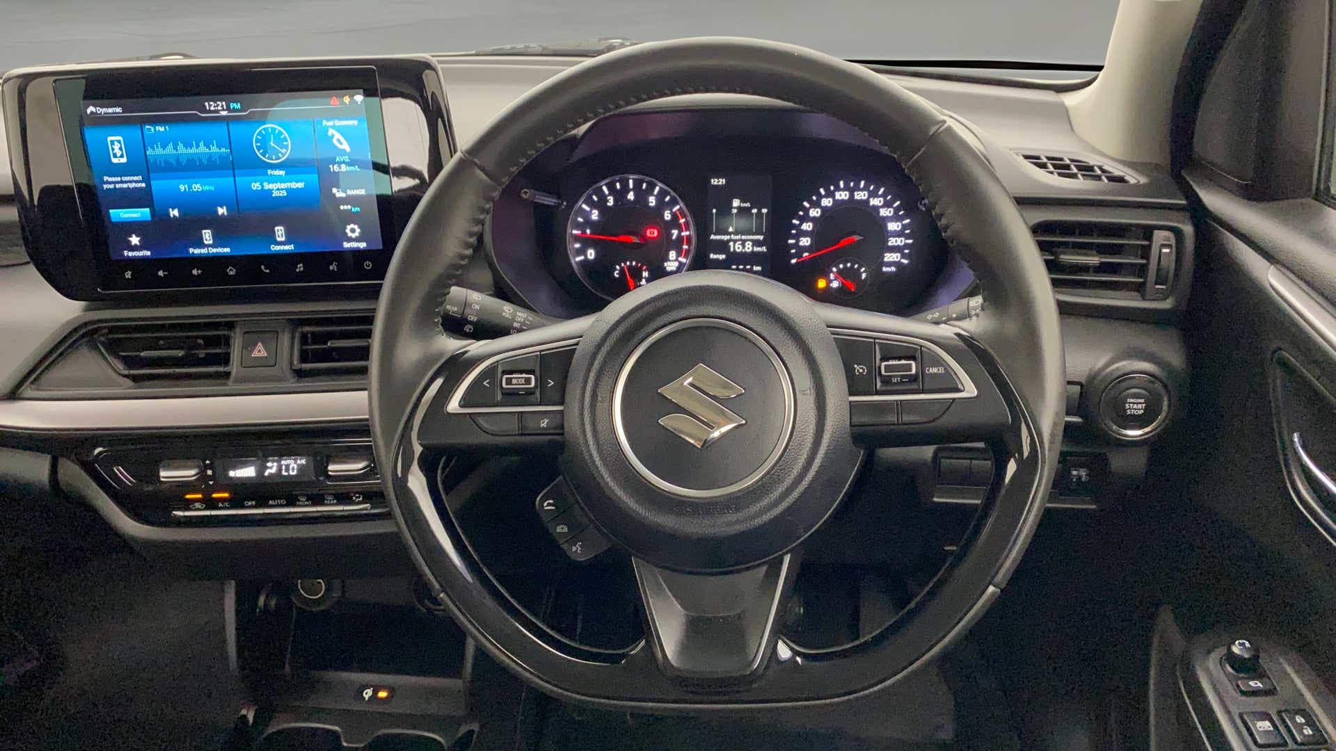 Dashboard and steering wheel of a Maruti Suzuki Swift
