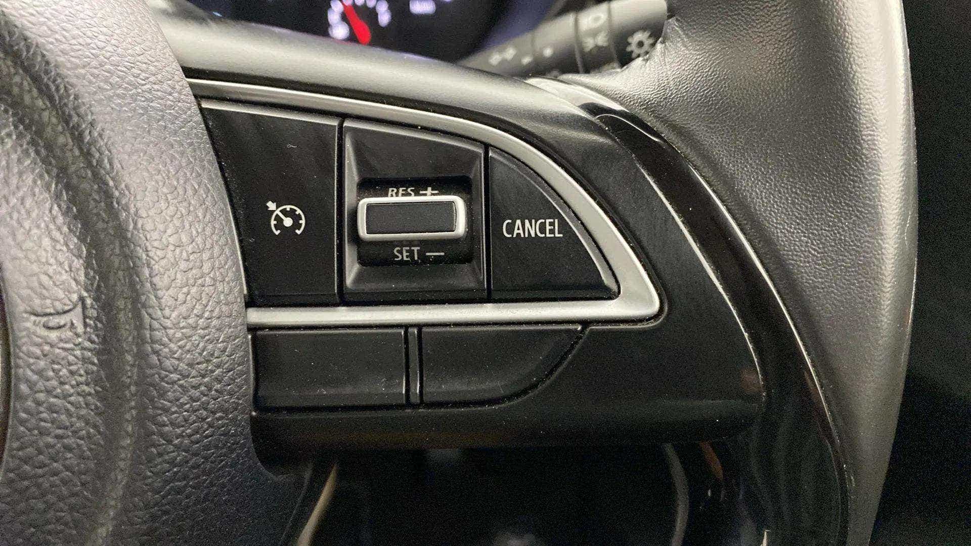 Cruise control steering wheel buttons of a Maruti Suzuki Swift