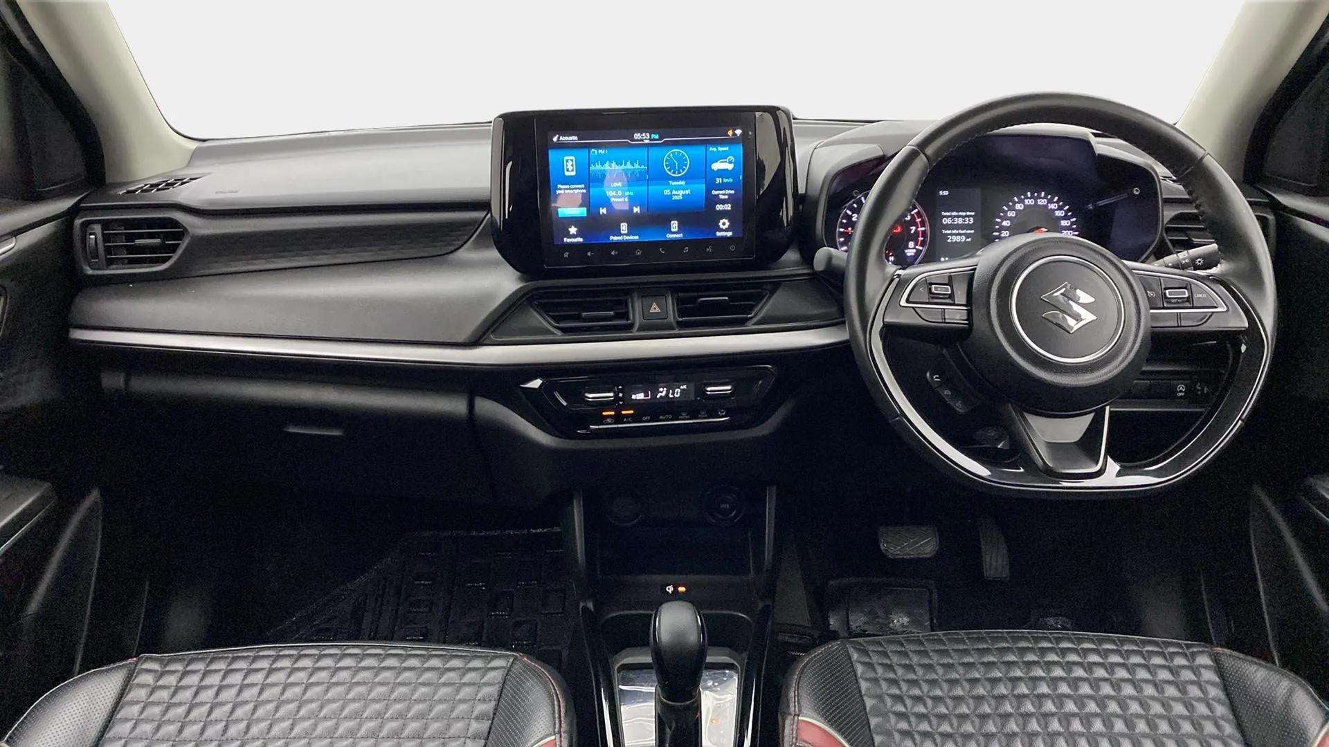 Interior dashboard view of a Maruti Suzuki Swift