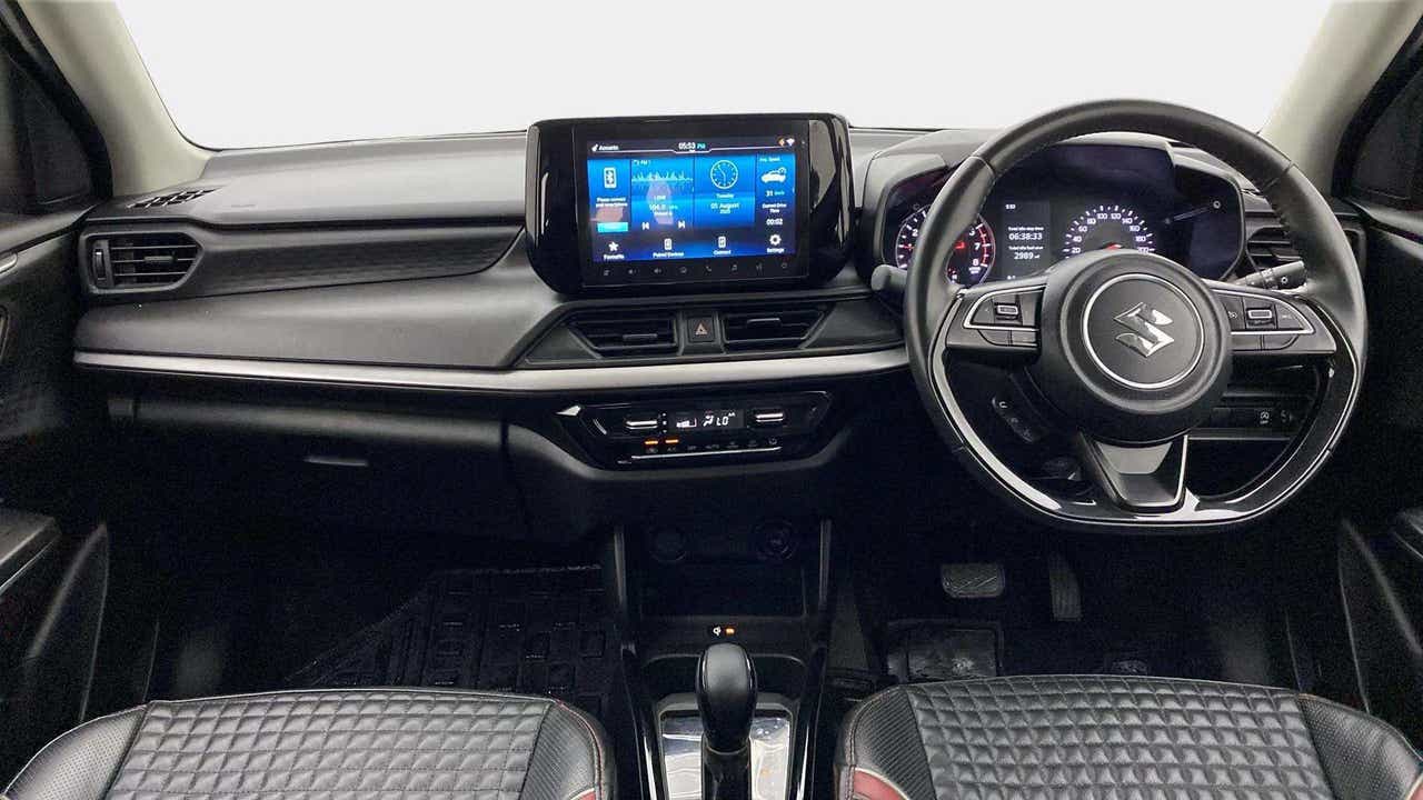 Interior dashboard view of a Maruti Suzuki Swift