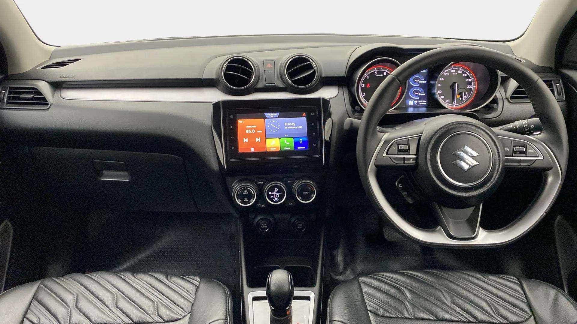 Interior dashboard view of a Maruti Suzuki Swift